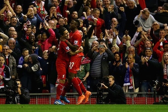 LIVERPOOL, ENGLAND - APRIL 20:  Divock Origi of Liverpool celebrates with Roberto Firminho after scoring the opening goal during the Barclays Premier League match between Liverpool and Everton at Anfield, April 20, 2016, Liverpool, England  (Photo by Cliv