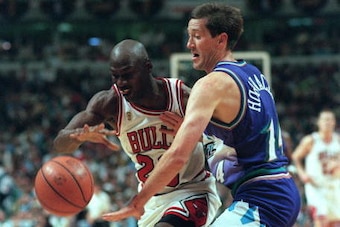 CHICAGO, UNITED STATES:  Chicago Bull player Michael Jordan (L) tries to get around Jeff Hornacek of Utah Jazz 01 June 1997 during the first half of game one of the NBA Finals at the United Center in Chicago, Il. AFP PHOTO/JEFF HAYNES (Photo credit should