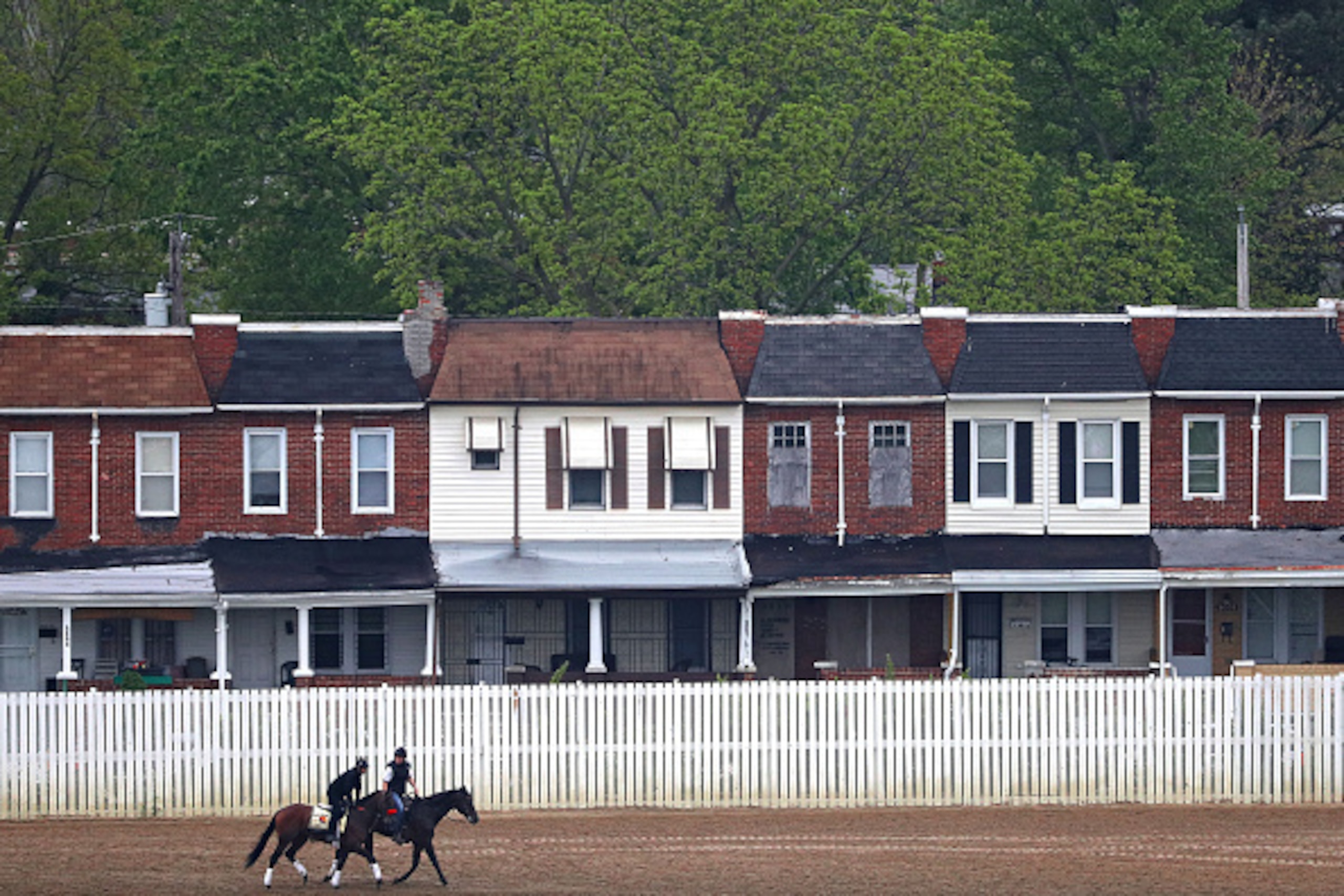 BALTIMORE, MD - MAY 18: Kentucky Derby winner Nyquist (left) is walked by exercise rider Jonny Garcia on track with an outrider (right) during a training session for the 141st running of the Preakness Stakes at Pimlico Race Course on on May 18, 2016 in Ba