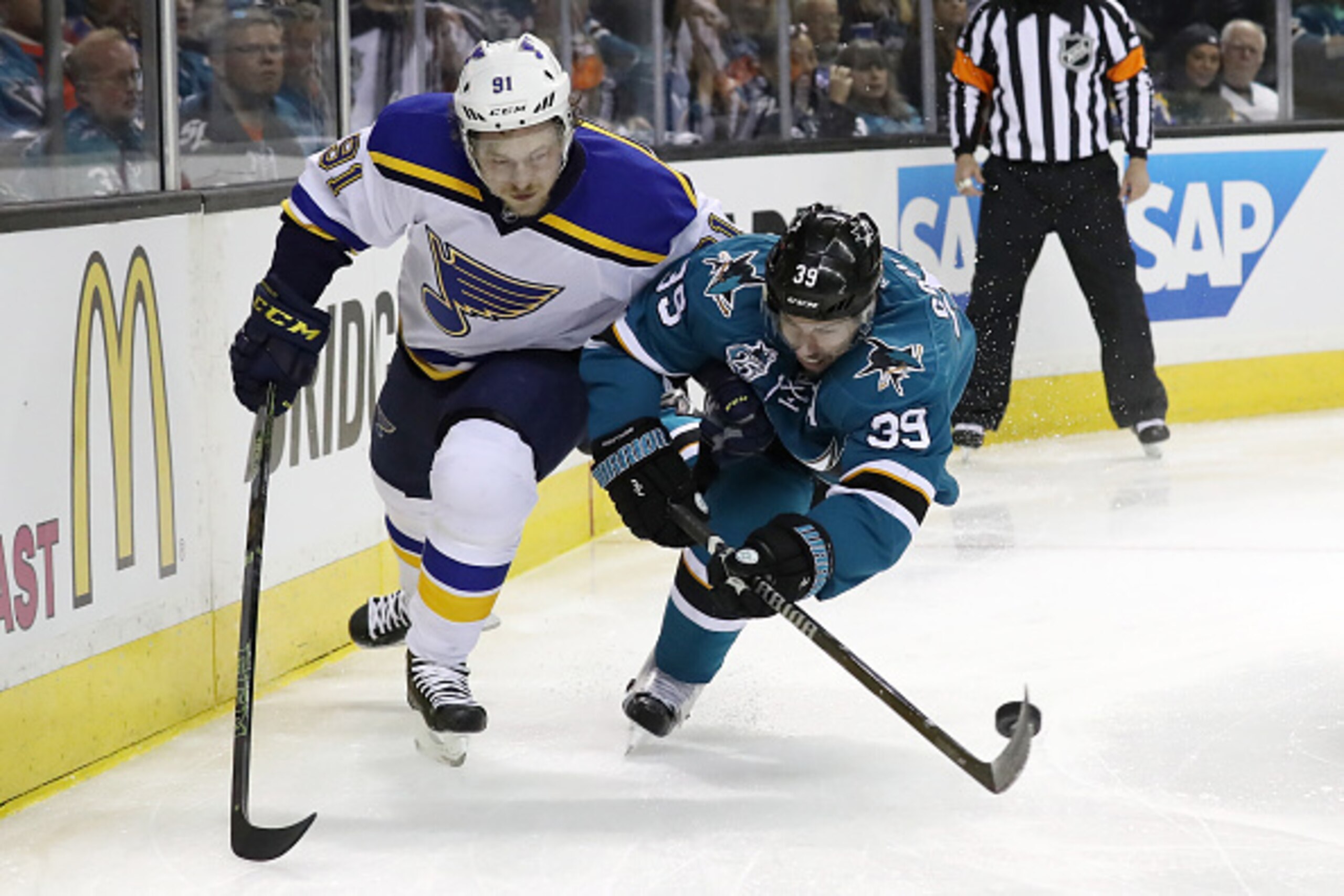 SAN JOSE, CA - MAY 19: Logan Couture #39 of the San Jose Sharks controls the puck against Vladimir Tarasenko #91 of the St. Louis Blues in game three of the Western Conference Finals during the 2016 NHL Stanley Cup Playoffs at SAP Center on May 19, 2016 SAN JOSE, CA - MAY 19: Logan Couture #39 of the San Jose Sharks controls the puck against Vladimir Tarasenko #91 of the St. Louis Blues in game three of the Western Conference Finals during the 2016 NHL Stanley Cup Playoffs at SAP Center on May 19, 2016