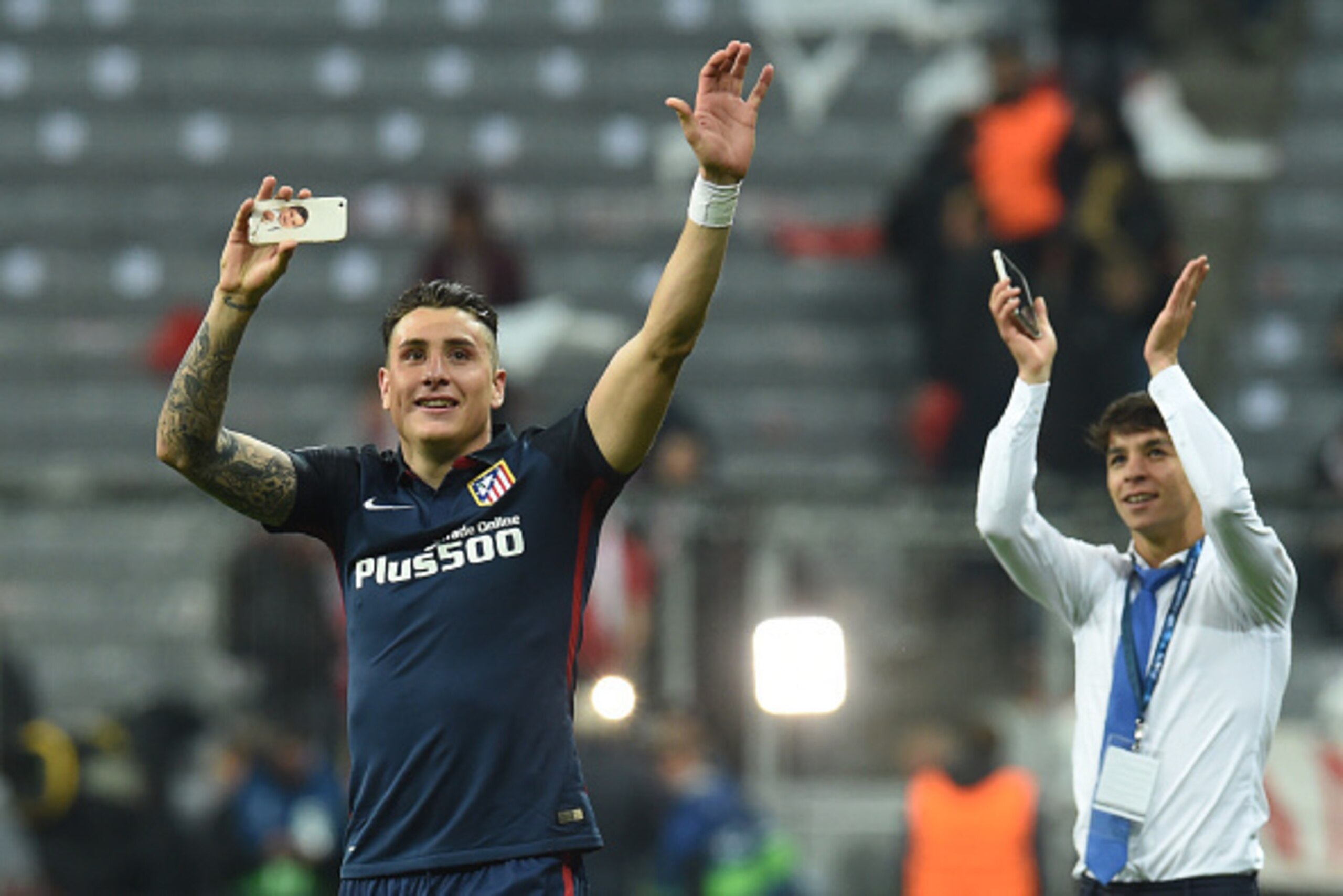 Atletico Madrid's Uruguayan defender Jose Maria Gimenez (L) and a teammate celebrate qualifying for the final after the UEFA Champions League semi-final, second-leg football match between FC Bayern Munich and Atletico Madrid in Munich, southern Germany, o