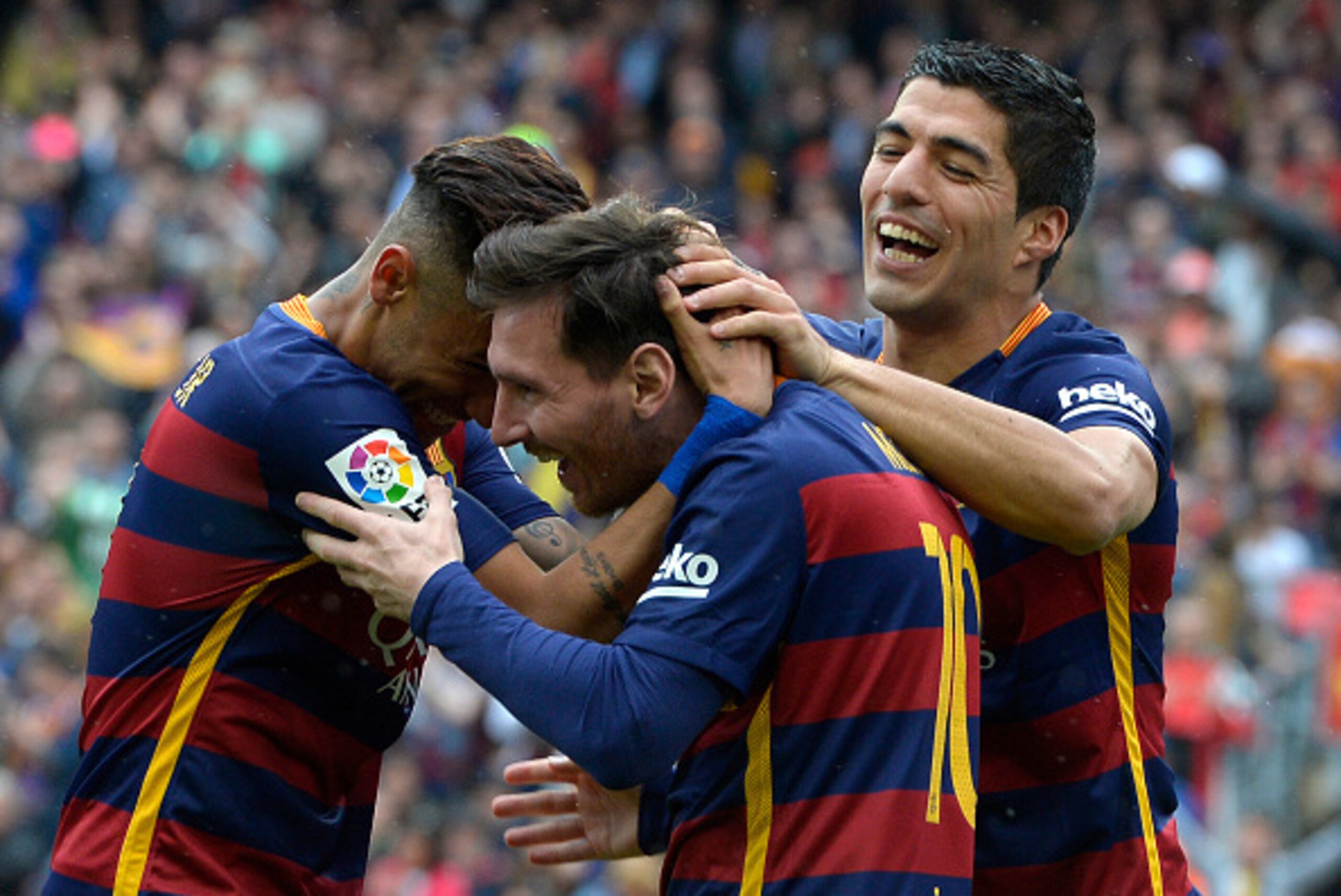 Barcelona's Argentinian forward Lionel Messi (C) celebrates with Barcelona's Brazilian forward Neymar and Barcelona's Uruguayan forward Luis Suarez (R) after scoring a goal during the Spanish league football match FC Barcelona vs RCD Espanyol at the Camp 