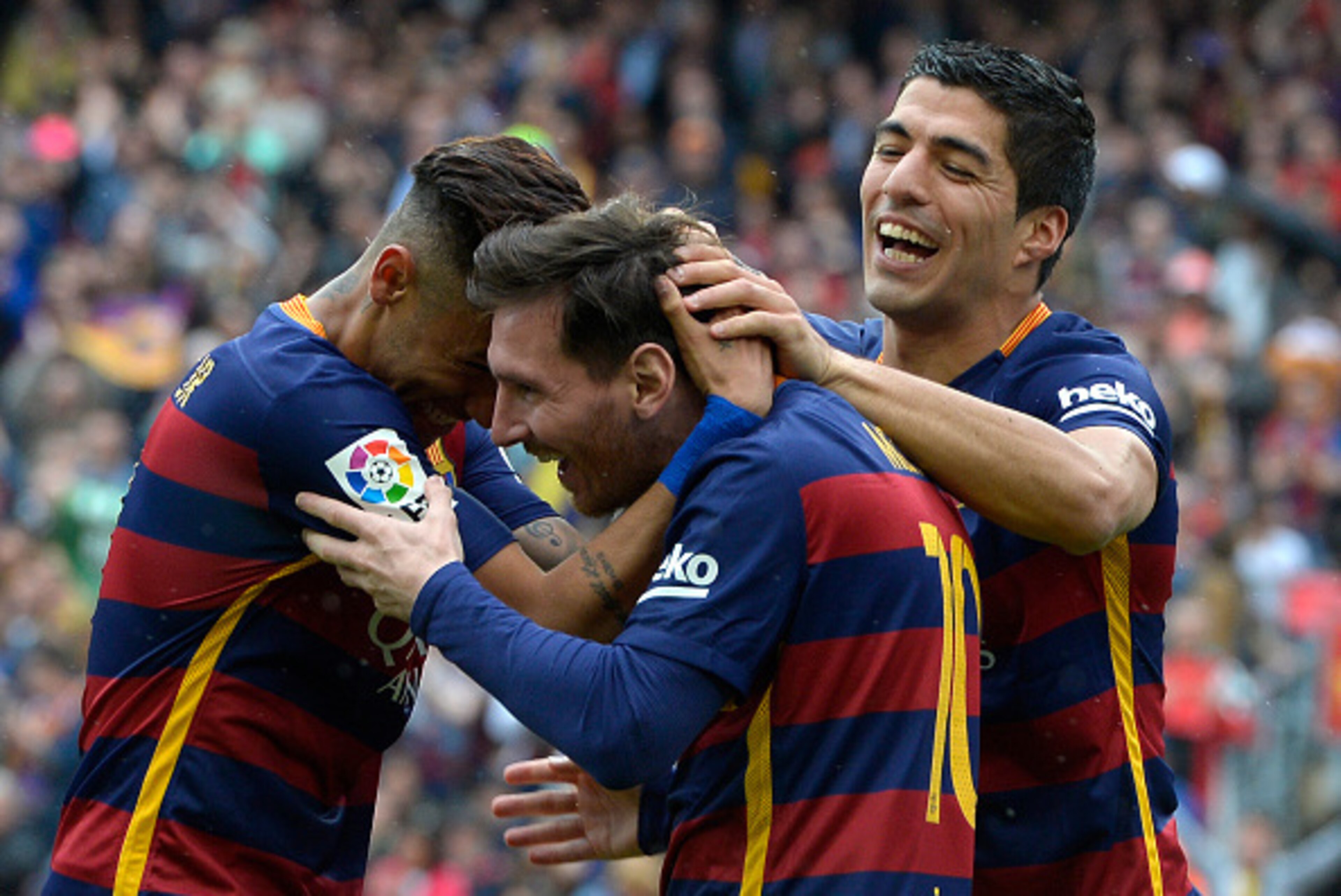 Barcelona's Argentinian forward Lionel Messi (C) celebrates with Barcelona's Brazilian forward Neymar and Barcelona's Uruguayan forward Luis Suarez (R) after scoring a goal during the Spanish league football match FC Barcelona vs RCD Espanyol at the Camp 