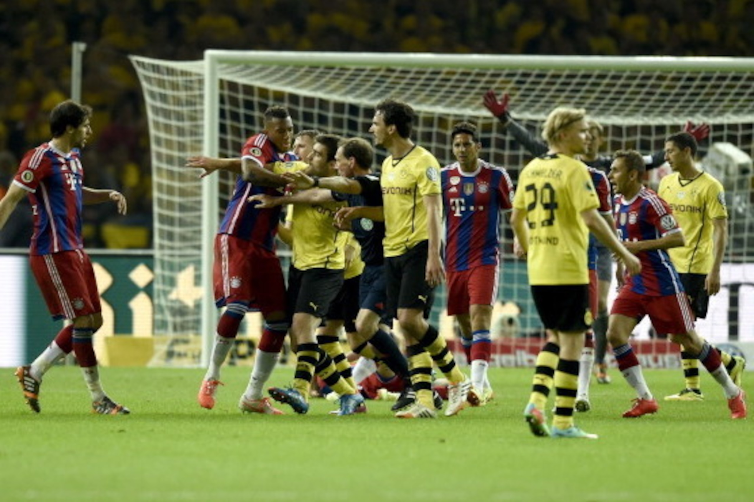 Referee Florian Meyer (5thL) tries to calm down Dortmund's Greek defender Sokratis (4thL) arguing with Bayern Munich's Spanish midfielder Javier Martinez (L) during the DFB German Cup final football match BVB Borussia Dortmund vs Bayern Munich at the Olym