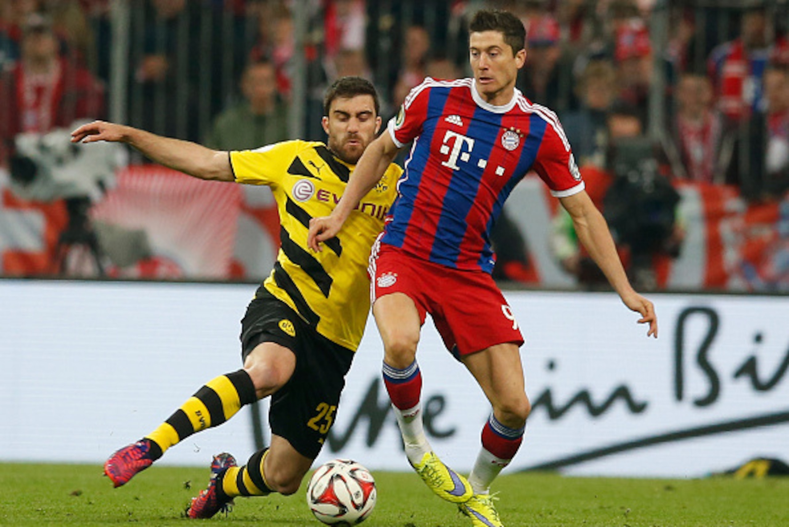 MUNICH, GERMANY - APRIL 28:  Robert Lewandowski (R) of Muenchen is challenged by Sokratis of Dortmund during the DFB Cup semi final match between FC Bayern Muenchen and Borussia Dortmund at Allianz Arena on April 28, 2015 in Munich, Germany.  (Photo by Bo
