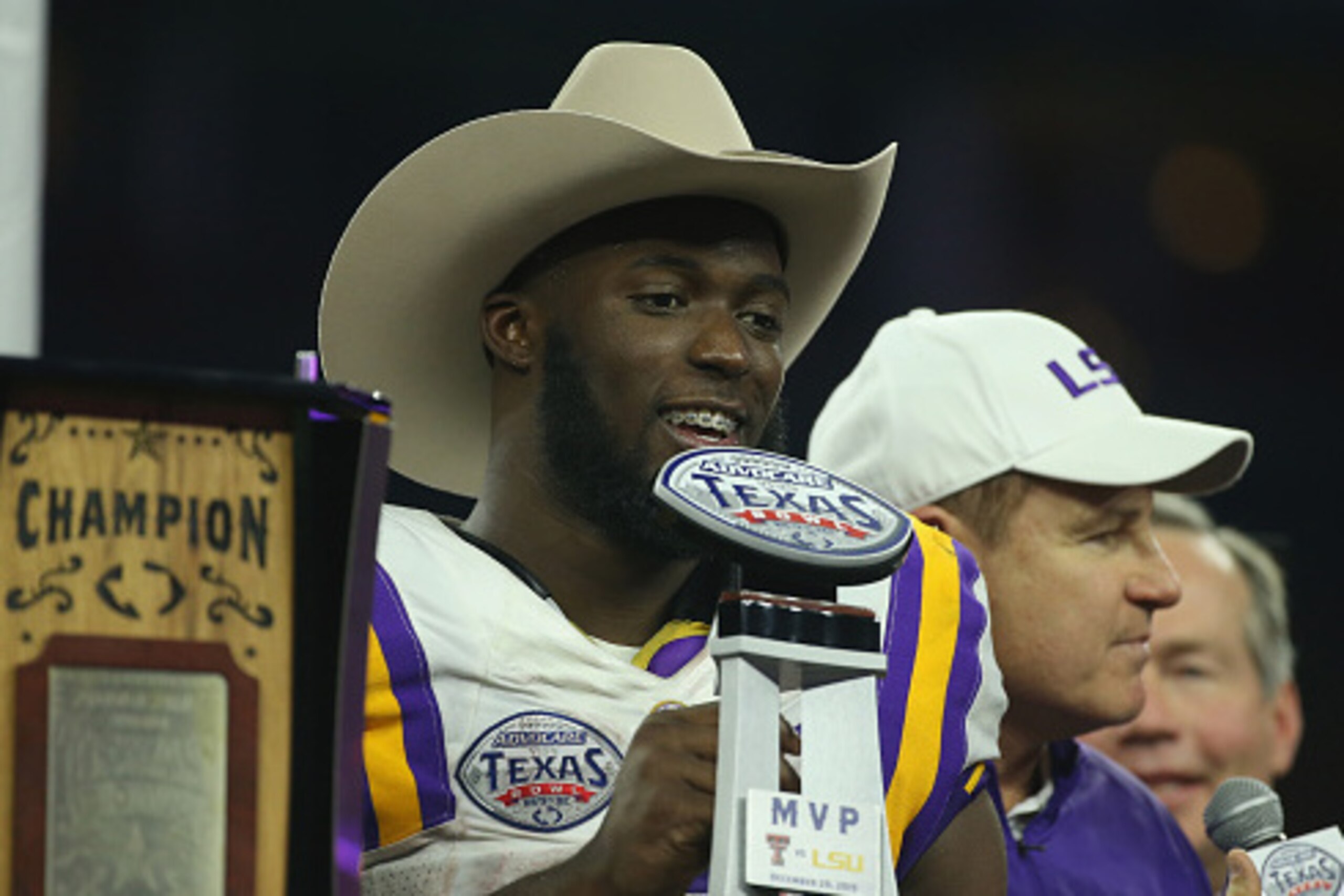 HOUSTON, TX - DECEMBER 29:  Leonard Fournette #7 of the LSU Tigers and his head coach Les Miles pose on stage after the Tigers beat the Texas Tech Red Raiders 56-27 during the AdvoCare V100 Texas Bowl at NRG Stadium on December 29, 2015 in Houston, Texas.