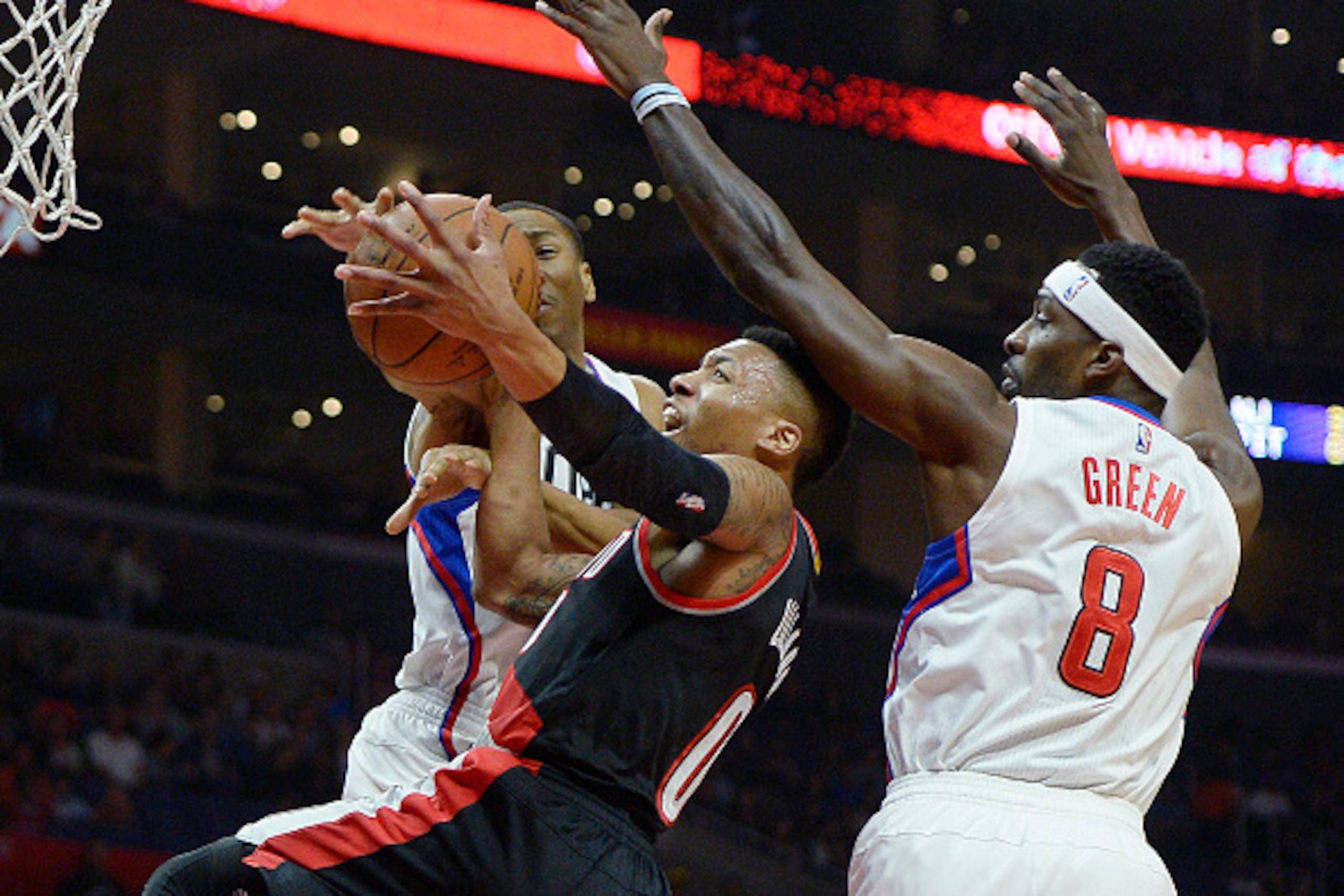 LOS ANGELES, CA - MARCH 24: Damian Lillard #0 of the Portland Trail Blazers has the ball knocked out of his hands by Wesley Johnson #33 of the Los Angeles Clippers with and Jeff Green #8 of the Los Angeles Clippers defending during the first half of the b
