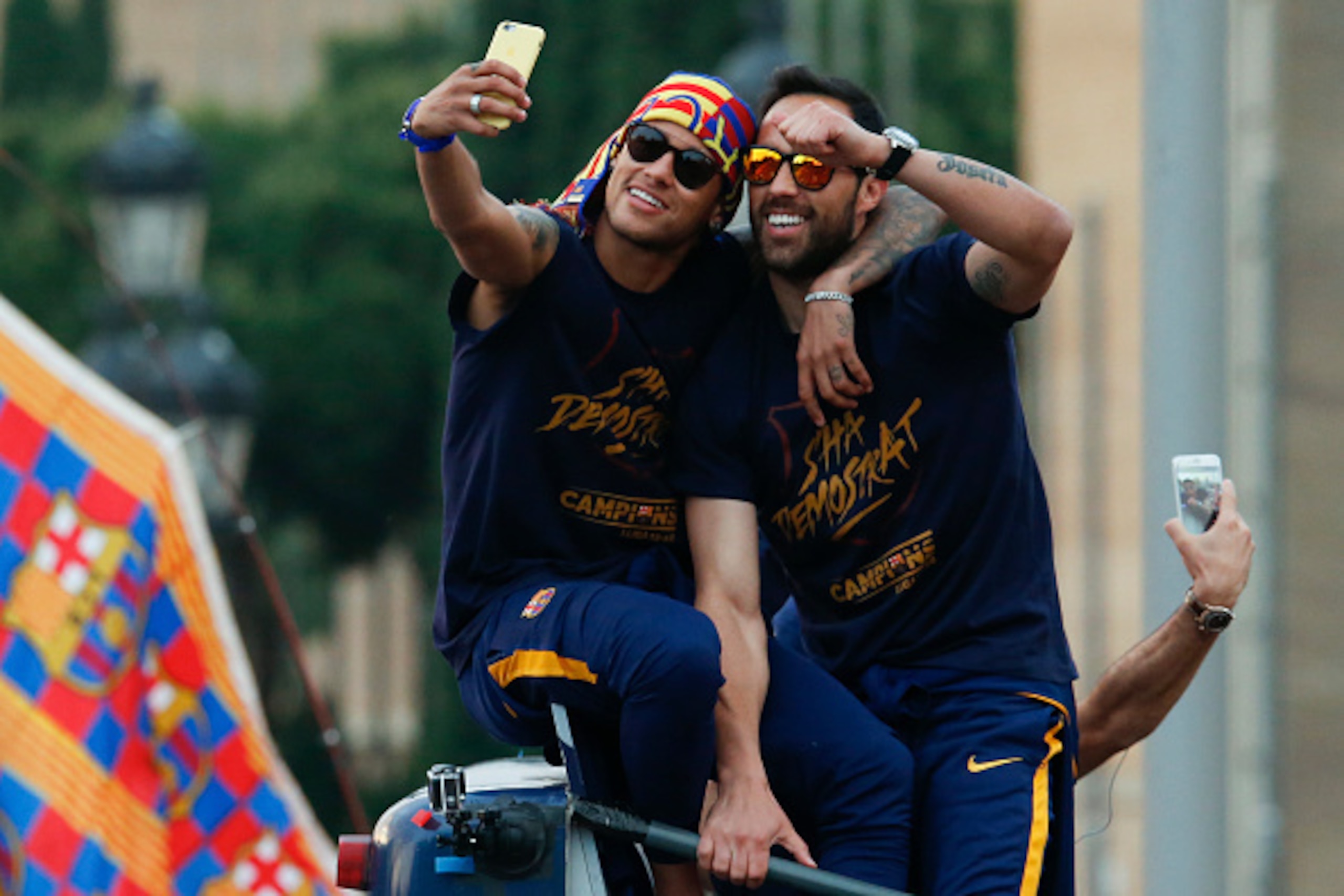 TOPSHOT - Barcelona's Brazilian forward Neymar (L) and Barcelona's Chilean goalkeeper Claudio Bravo take a selfie photo as they parade with their team on a bus through the streets of Barcelona to celebrate their 24th La Liga title, in Barcelona, on May 15 TOPSHOT - Barcelona's Brazilian forward Neymar (L) and Barcelona's Chilean goalkeeper Claudio Bravo take a selfie photo as they parade with their team on a bus through the streets of Barcelona to celebrate their 24th La Liga title, in Barcelona, on May 15