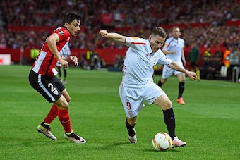 SEVILLE, SPAIN - APRIL 14: Kevin Gameiro of Sevilla goes past Eneko Boveda of Athletic Club Bilbao during the UEFA Europa League quarter final, second leg match between Sevilla and Athletic Bilbao at the Ramon Sanchez Pizjuan stadium on April 14, 2016 in 