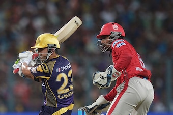 Kolkata Knight Riders captain Gautam Gambhir(L)is watched by Kings XI Punjab wicketkeeper Wriddhiman Saha as he plays a shot during the 2016 Indian Premier League(IPL) Twenty20 cricket match between Kolkata Knight Riders and Kings XI Punjab at The Eden Ga