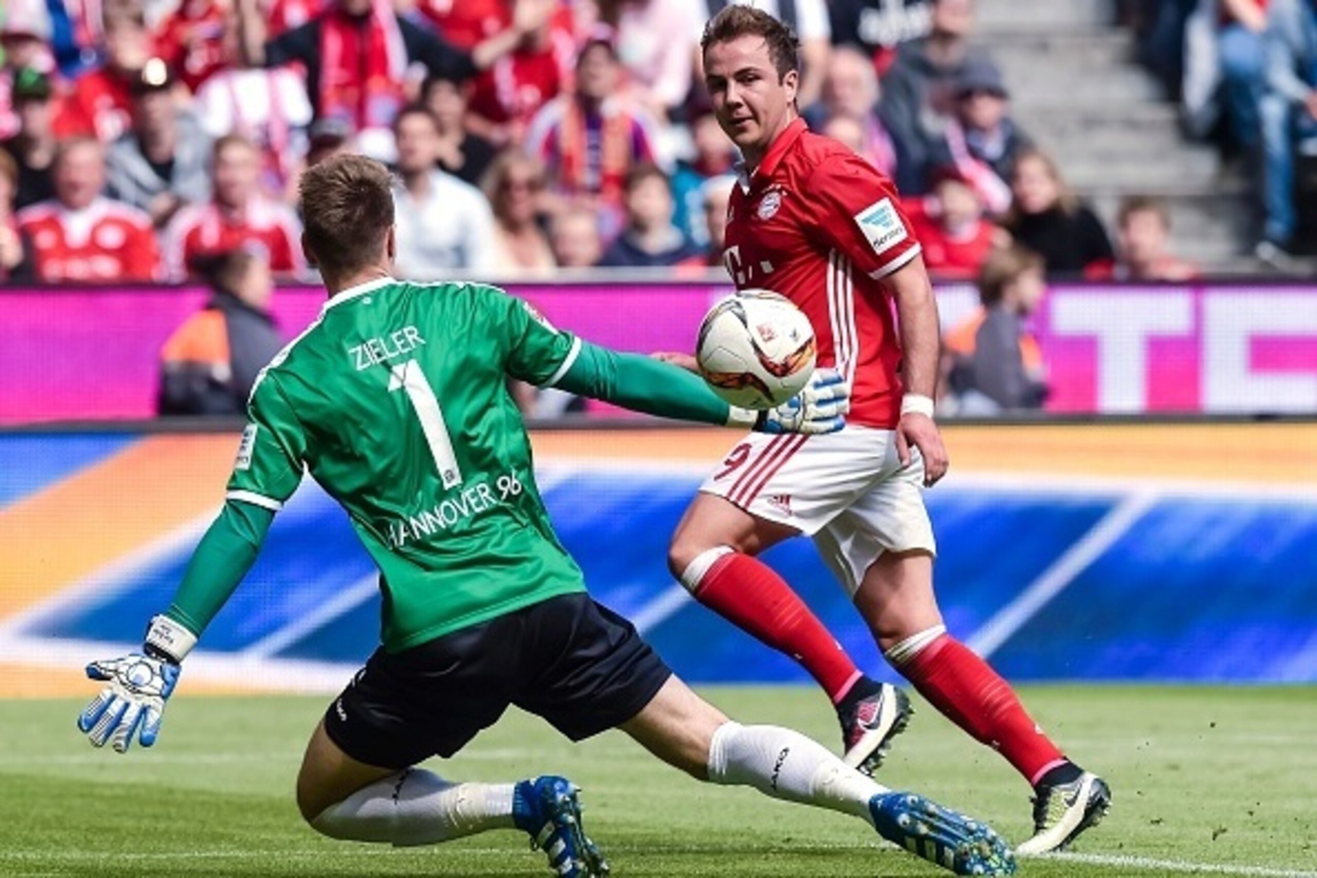 Bayern Munich's midfielder Mario Goetze (R) scores his sides second goal past Hanover's goalkeeper Ron-Robert Zieler during the German first division Bundesliga football match between FC Bayern Munich and Hannover 96 in Munich, southern Germany, on May 14
