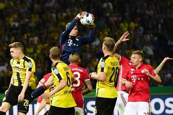 Bayern Munich's goalkeeper Manuel Neuer makes a save during the German Cup (DFB Pokal) final football match Bayern Munich vs Borussia Dortmund at the Olympic stadium in Berlin on May 21, 2016. / AFP / TOBIAS SCHWARZ / RESTRICTIONS: ACCORDING TO DFB RULES 