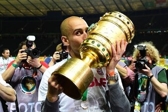 Bayern Munich's Spanish head coach Pep Guardiola kisses the trophy after Bayern Munich won the German Cup (DFB Pokal) final football match Bayern Munich vs Borussia Dortmund at the Olympic stadium in Berlin on May 21, 2016. / AFP / TOBIAS SCHWARZ / RESTRI