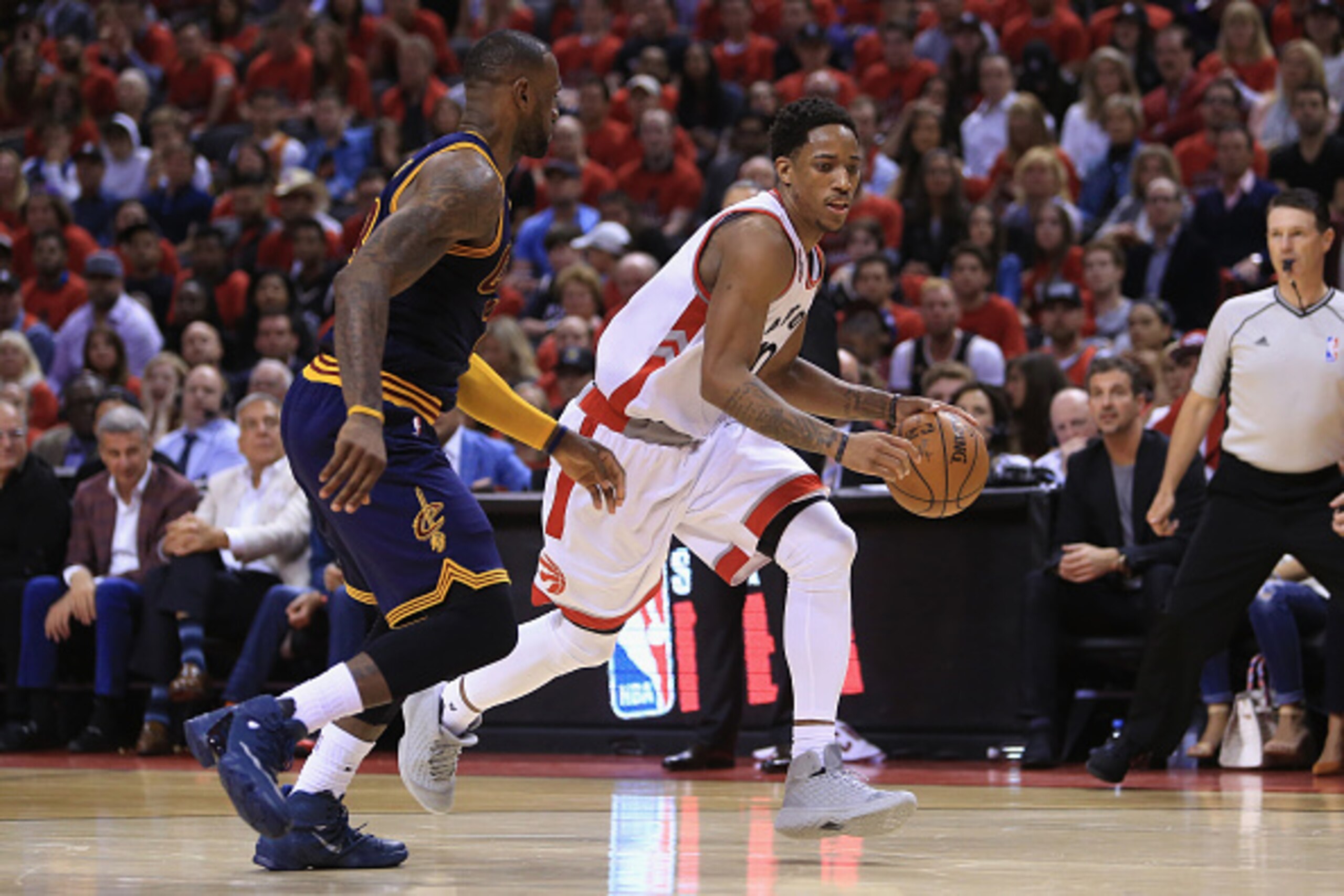 TORONTO, ON - MAY 21:  DeMar DeRozan #10 of the Toronto Raptors dribbles past LeBron James #23 of the Cleveland Cavaliers during the second half in game three of the Eastern Conference Finals during the 2016 NBA Playoffs at Air Canada Centre on May 21, 20