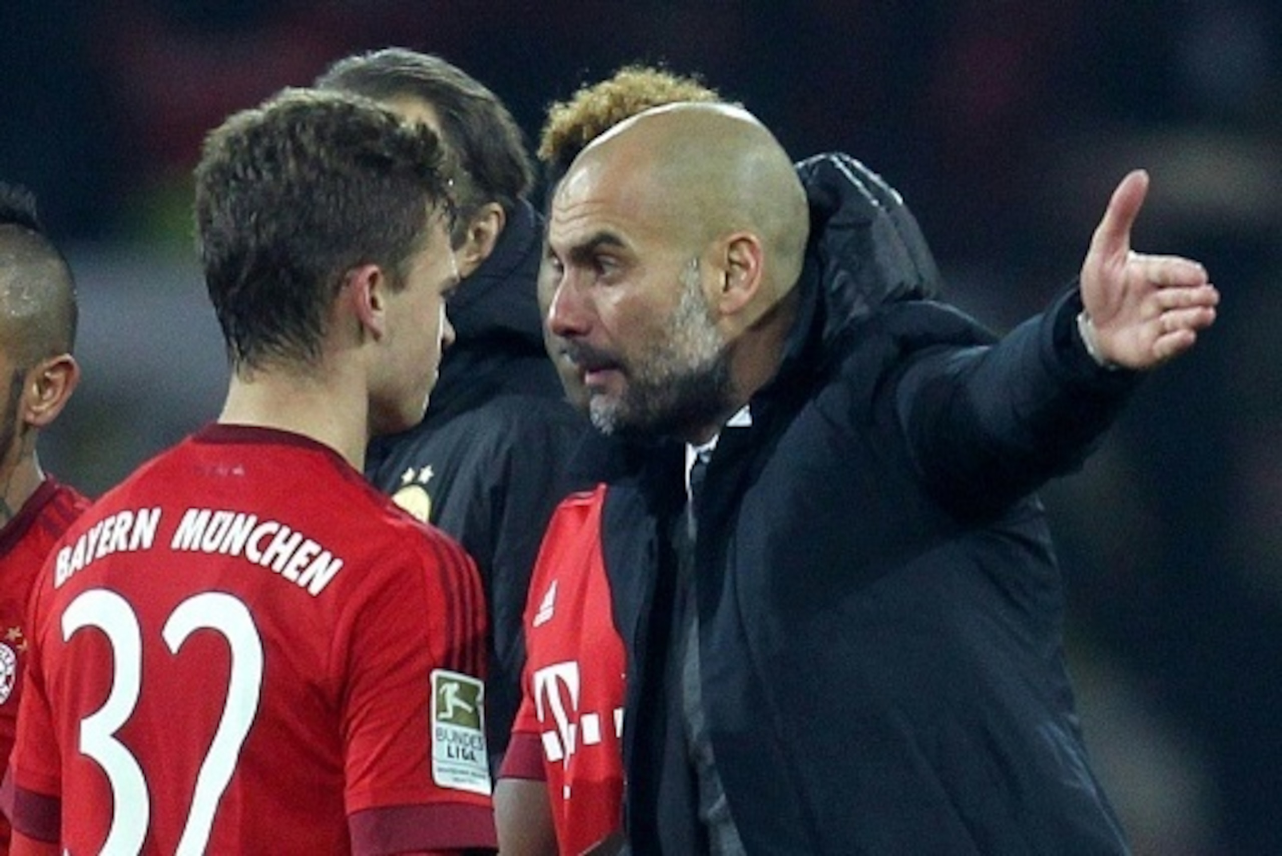 Bayern Munich's Spanish head coach Pep Guardiola reacts to midfielder Joshua Kimmich during the German first division Bundesliga football match of Borussia Dortmund v FC Bayern Muenchen in Dortmund, on March 5, 2016. / AFP / Ina Fassbender / NO Getty Imag