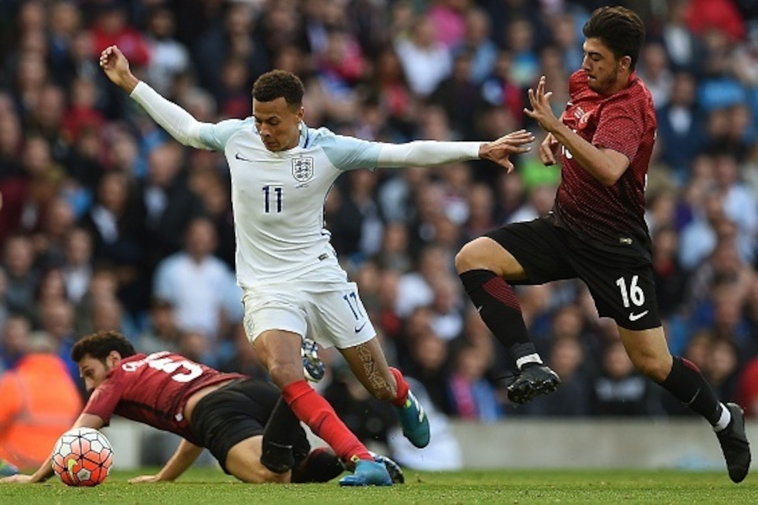 England's midfielder Dele Alli (C) vies with Turkey's striker Hakan Calhanoglu (L) and Turkey's midfielder Ozan Tufan during the friendly football match between England and Turkey at the Etihad Stadium in Manchester, north west England, on May 22, 2016. /