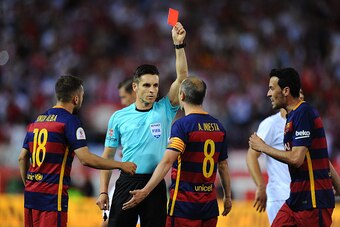 MADRID, SPAIN - MAY 22:  Barcelona players protest while Referee Carlos del Cerro Grande hands Javier Mascherano of FC Barcelona the red card for during the Copa del Rey Final between Barcelona and Sevilla at Vicente Calderon Stadium    on May 22, 2016 in