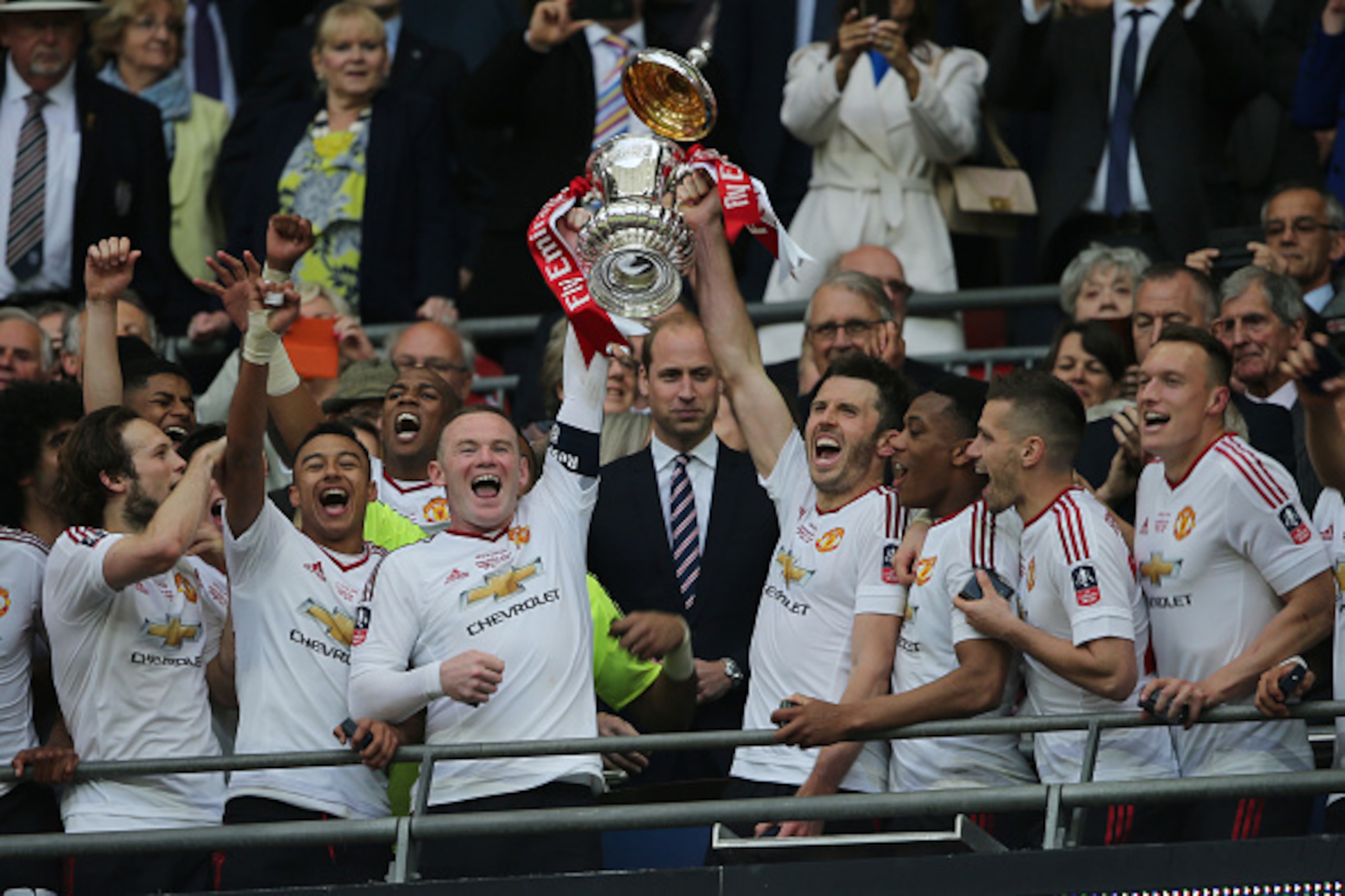 LONDON, ENGLAND - MAY 21:  Michael Carrick and Wayne Rooney of Manchester United lift the trophy following their 1-2 victory at the end of extra time during The Emirates FA Cup final match between Manchester United and Crystal Palace at Wembley Stadium on