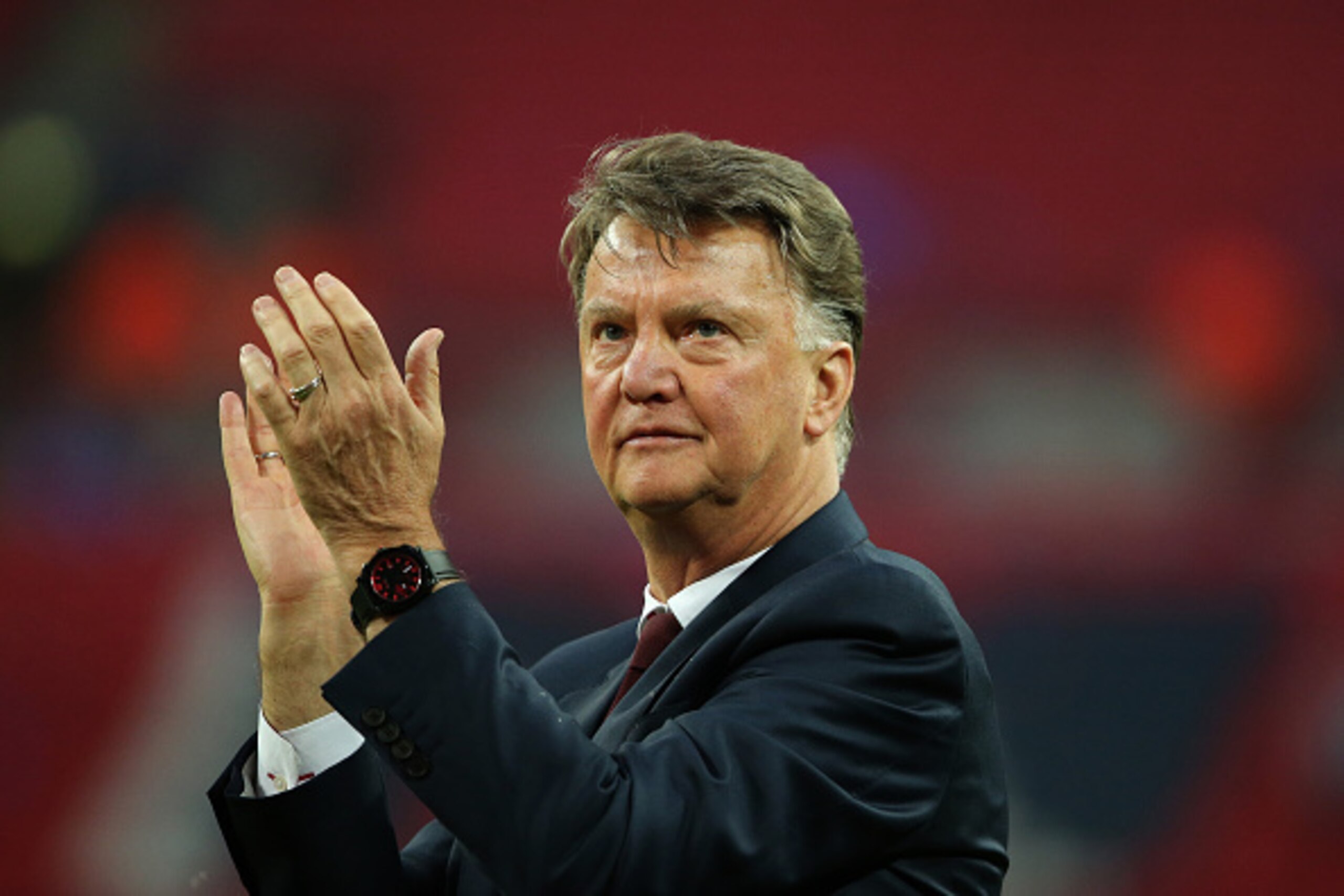 LONDON, ENGLAND - MAY 21: LONDON, ENGLAND - MAY 21: Louis van Gaal Manager / head coach of Manchester United watches his players celebrate victory after The Emirates FA Cup final match between Manchester United and Crystal Palace at Wembley Stadium on May