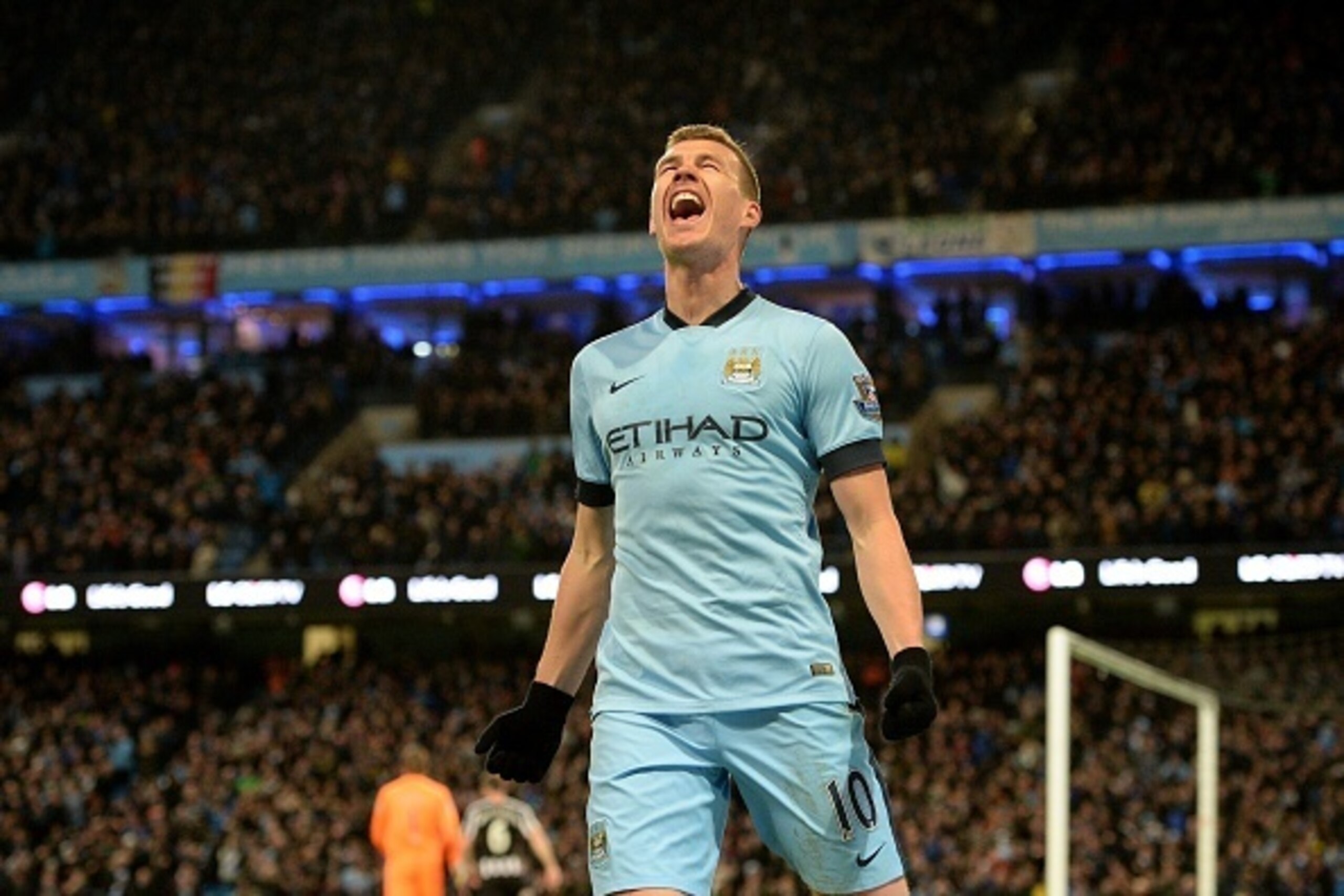Manchester City's Bosnian striker Edin Dzeko celebrates after scoring his team's third goal during the English Premier League football match between Manchester City and Newcastle at the The Etihad Stadium in Manchester, north west England on February 21, 