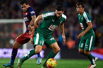 BARCELONA, SPAIN - OCTOBER 25:  Daniel Alves (L) of Barcelona competes for the ball with Borja Gonzalez Tomas 'Baston' of Eibar during the La Liga match between FC Barcelona and SD Eibar at Camp Nou Stadium on October 25, 2015 in Barcelona, Spain.  (Photo