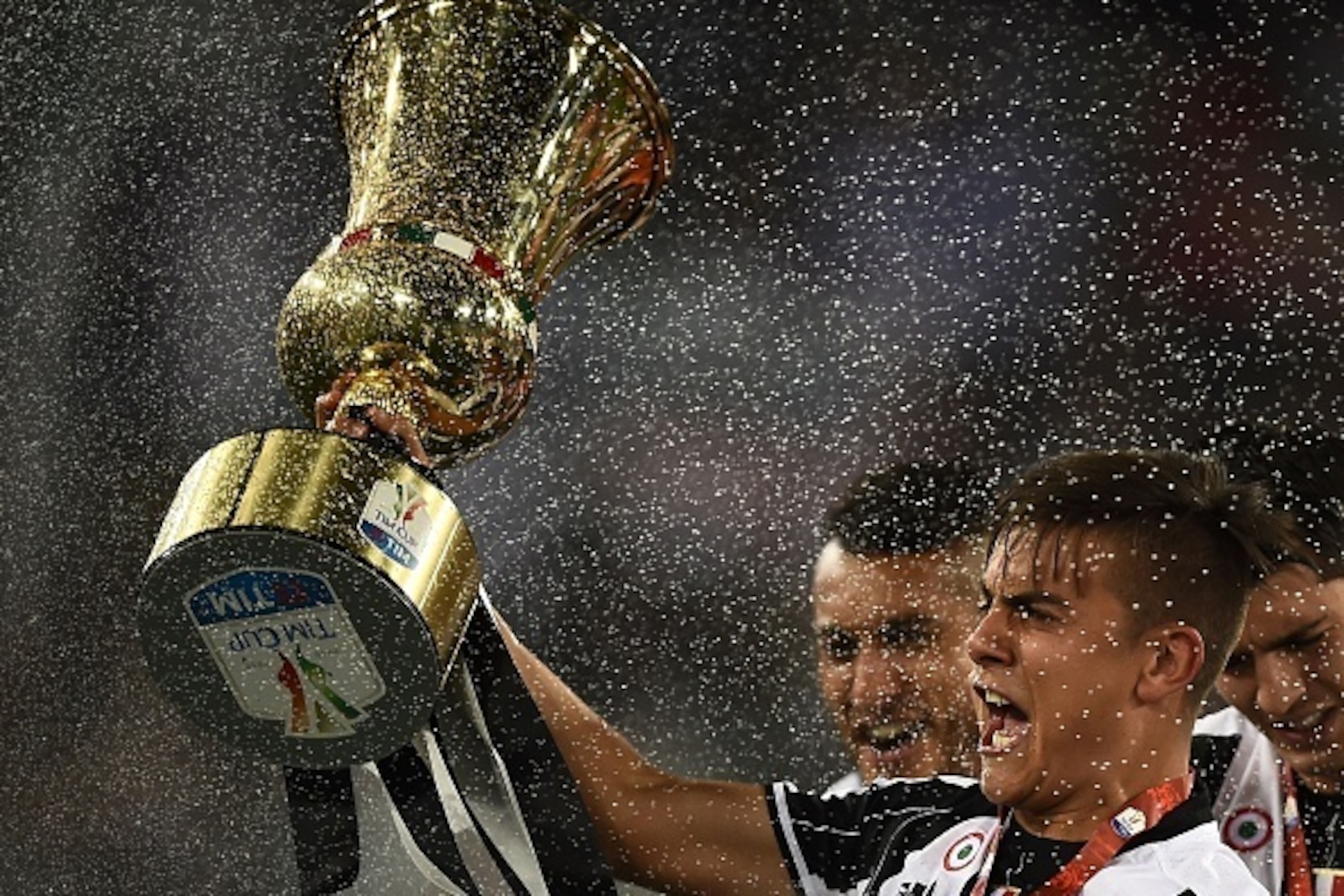 Juventus' forward from Argentina Paulo Dybala celebrates with the trophy after winning the Italian Tim Cup final football match AC Milan vs Juventus on May 21, 2016 at the Olympic Stadium in Rome.  Juventus won 0-1 in the extra time.    AFP PHOTO / FILIPP