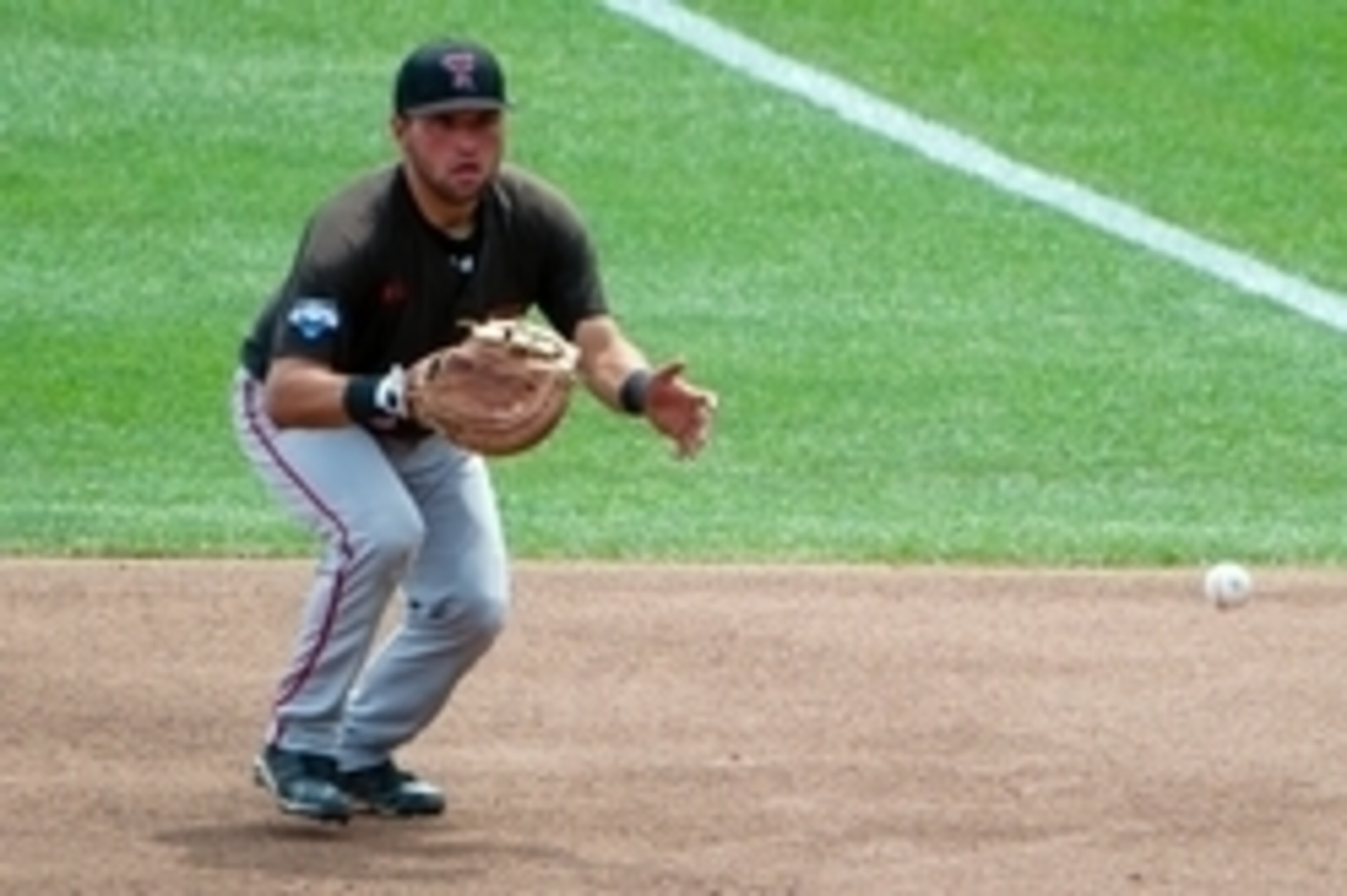 Jun 17, 2014; Omaha, NE, USA; Texas Tech Red Raiders pitcher Eric Gutierrez (12) field a ground ball against the Mississippi Rebels during game seven of the 2014 College World Series at TD Ameritrade Park Omaha. Mandatory Credit: Steven Branscombe-USA TOD Jun 17, 2014; Omaha, NE, USA; Texas Tech Red Raiders pitcher Eric Gutierrez (12) field a ground ball against the Mississippi Rebels during game seven of the 2014 College World Series at TD Ameritrade Park Omaha. Mandatory Credit: Steven Branscombe-USA TOD
