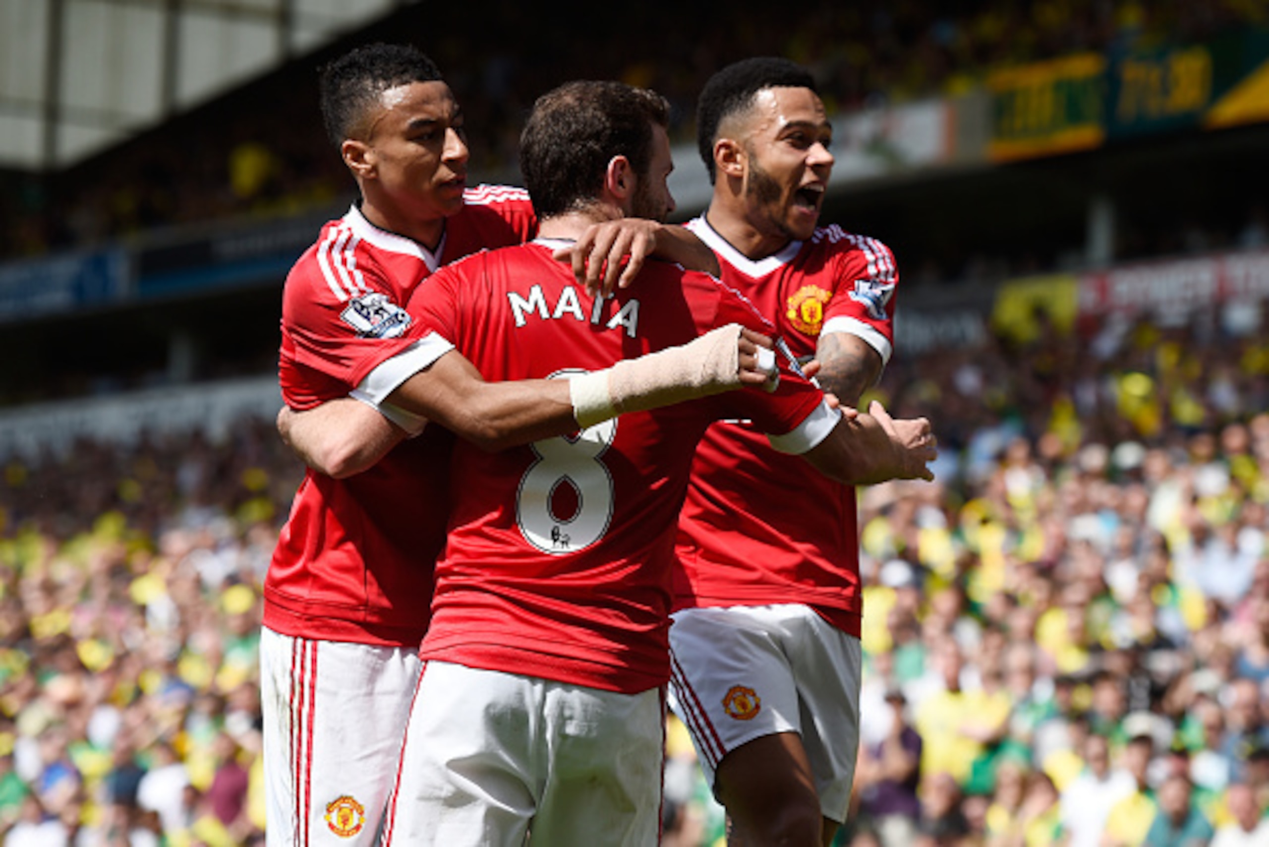 NORWICH, ENGLAND - MAY 07:  Juan Mata (C) of Manchester United celebrates scoring his team's first goal with his team mates Jesse Lingard (L) and Memphis Depay (R) during the Barclays Premier League match between Norwich City and Manchester United at Carr