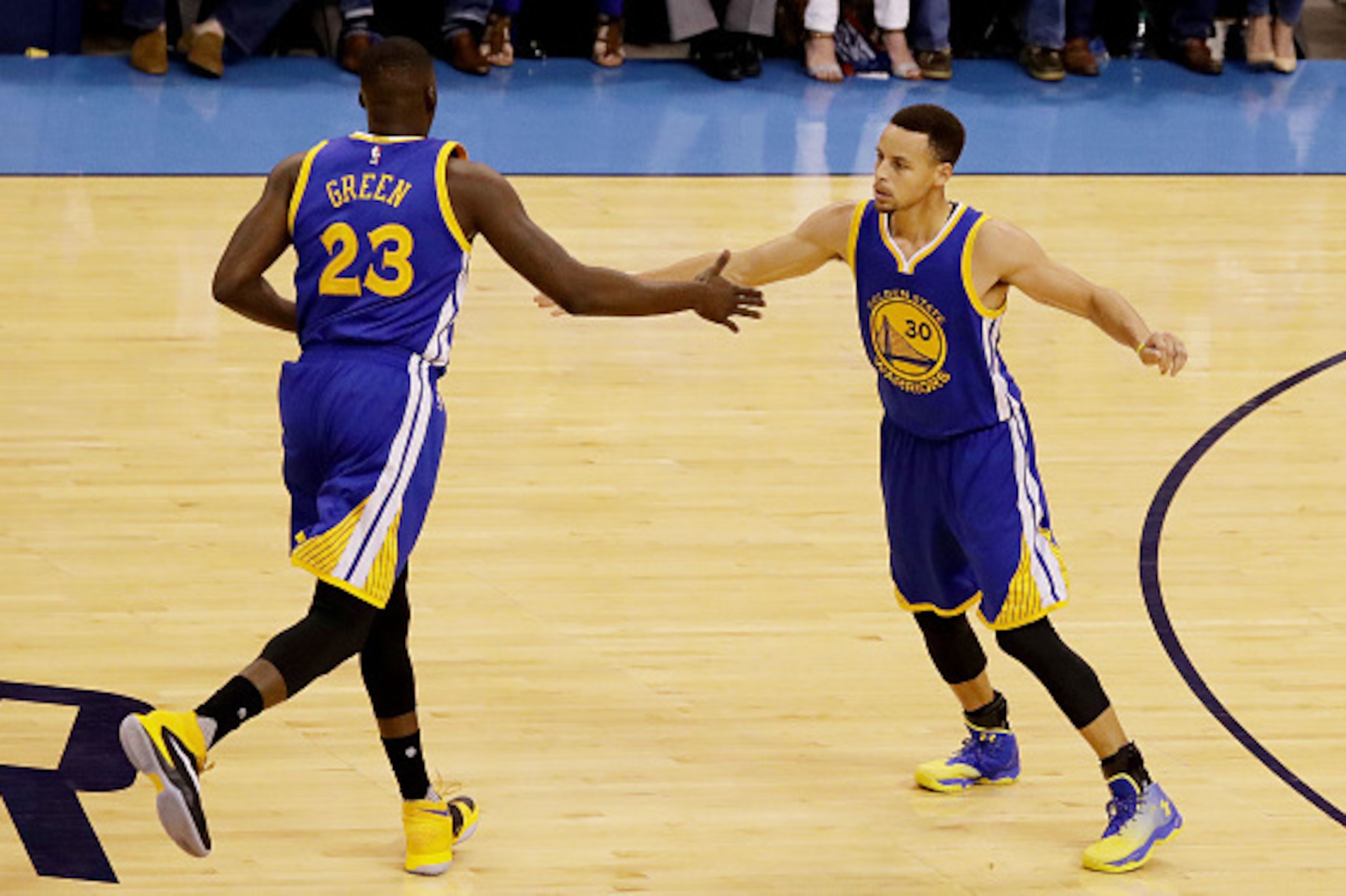 OKLAHOMA CITY, OK - MAY 22:  Stephen Curry #30 and Draymond Green #23 of the Golden State Warriors celebrate in the first quater against the Oklahoma City Thunder in game three of the Western Conference Finals during the 2016 NBA Playoffs at Chesapeake En