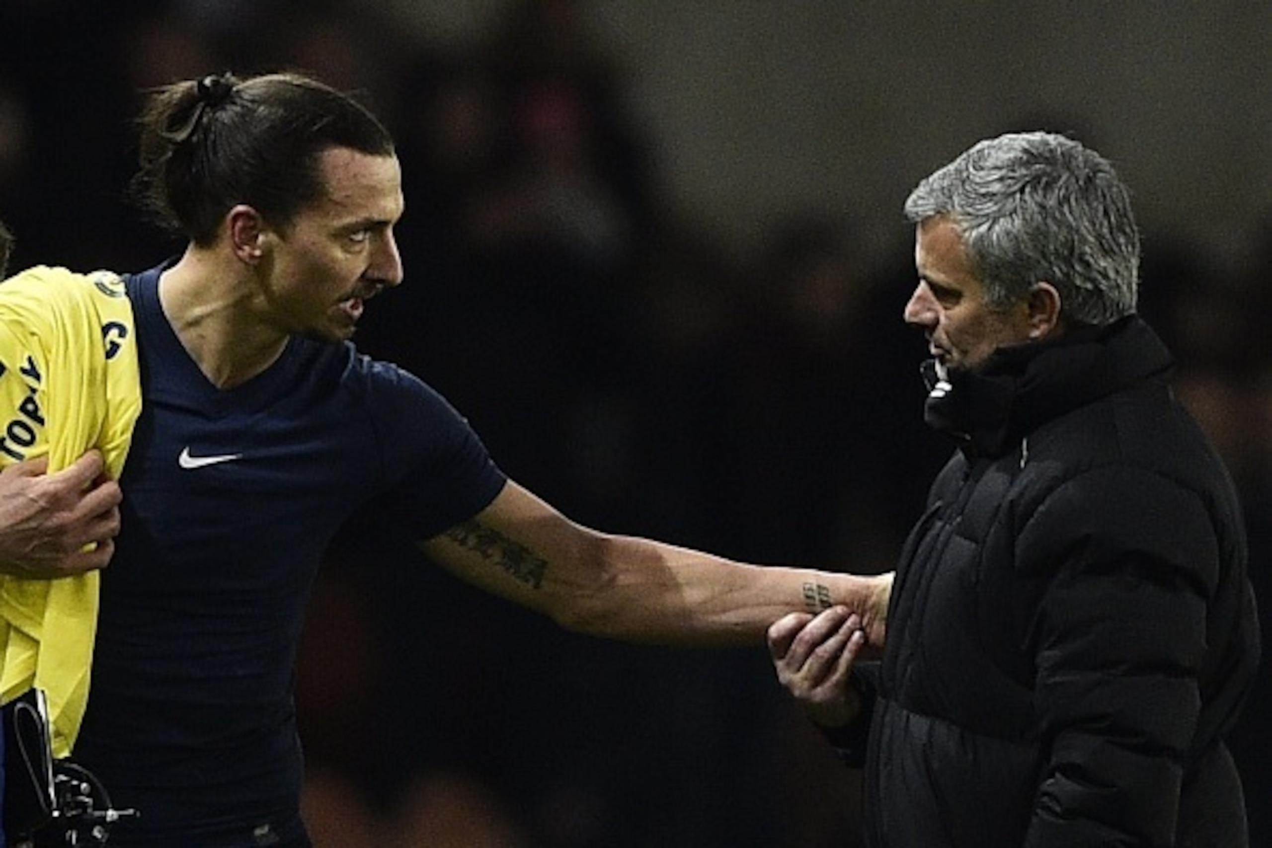 Paris Saint-Germain's Swedish midfielder Zlatan Ibrahimovic speaks with Chelsea's Portuguese manager Jose Mourinho (R) at the end of the UEFA Champions League round of 16 football match between Paris Saint-Germain (PSG) and Chelsea at the Parc des Princes