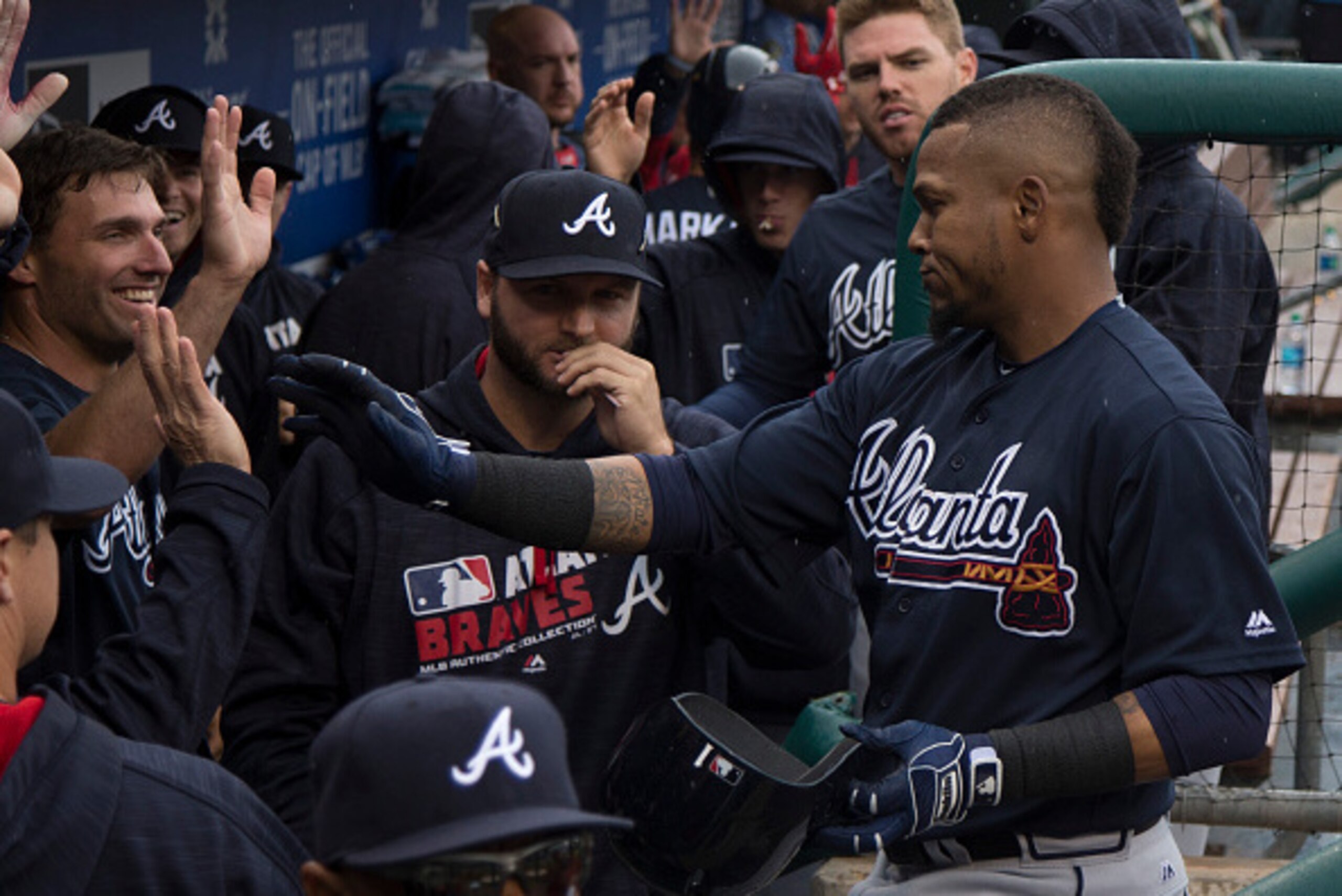 PHILADELPHIA, PA - MAY 21: Erick Aybar #1 of the Atlanta Braves high fives with his team after hitting a sacrifice fly in the top of the fourth inning against the Philadelphia Phillies at Citizens Bank Park on May 21, 2016 in Philadelphia, Pennsylvania. T