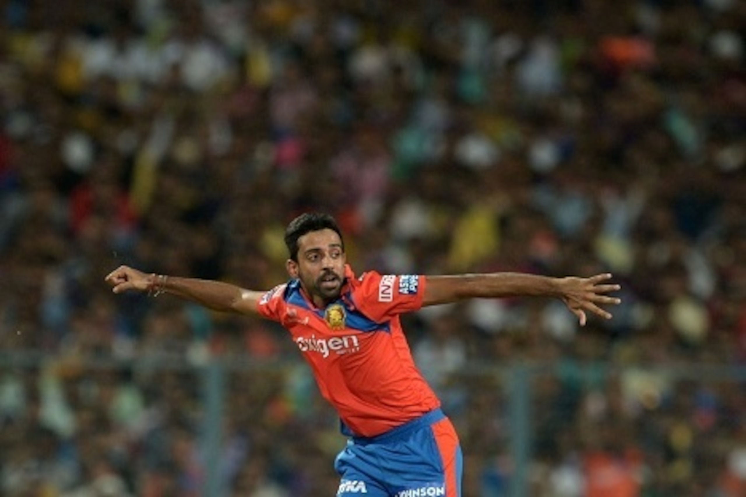 TOPSHOT - Gujarat Lions bowler Dhawal Kulkarni celebrates after the dismissal of Kolkata Knight Riders batsman Robin Uthappa during the 2016 Indian Premier League (IPL) Twenty20 cricket match between Kolkata Knight Riders and Gujarat Lions at The Eden Gar
