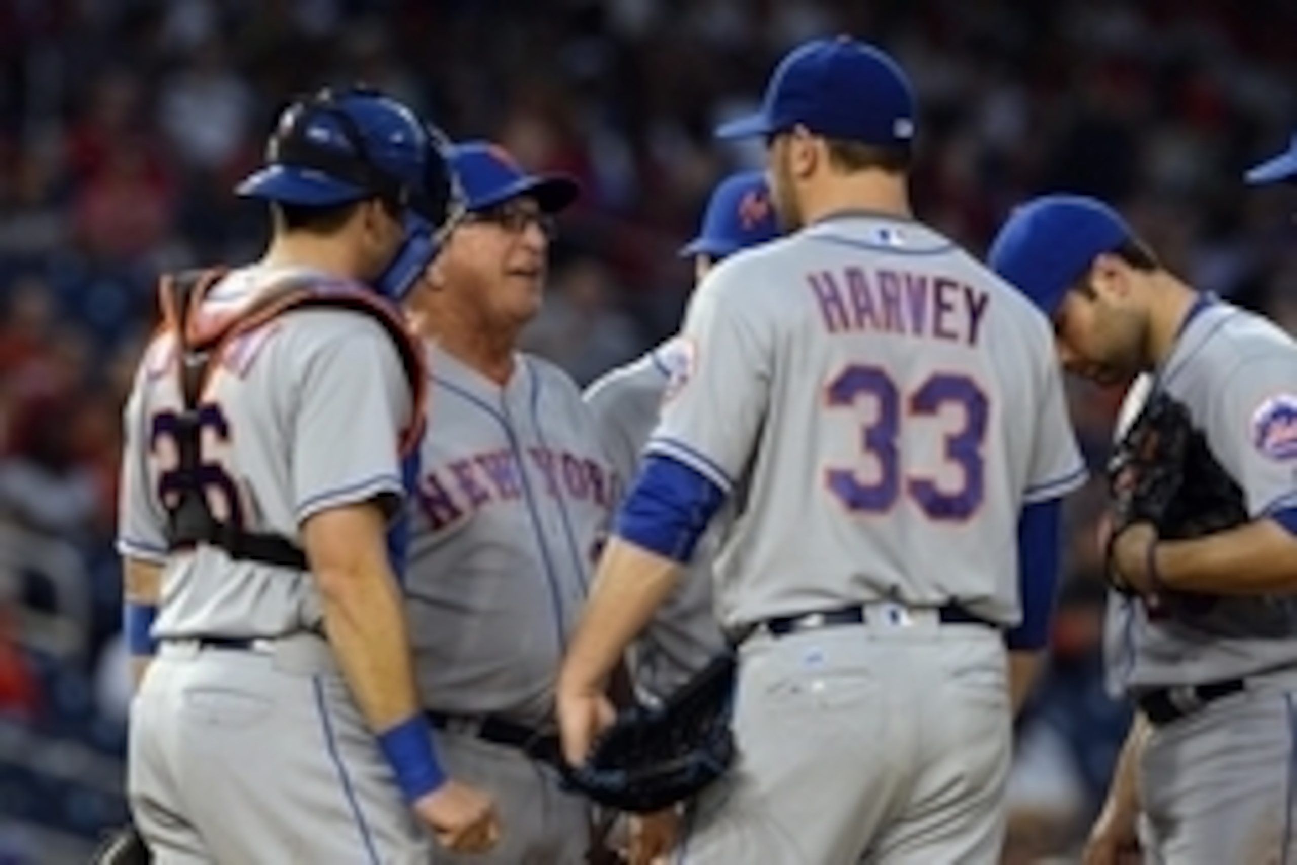 May 24, 2016; Washington, DC, USA; New York Mets pitching coach Dan Warthen (38) speaks with starting pitcher Matt Harvey (33) on the pitcher's mound during the fourth inning against the Washington Nationals at Nationals Park. Mandatory Credit: Tommy Gill