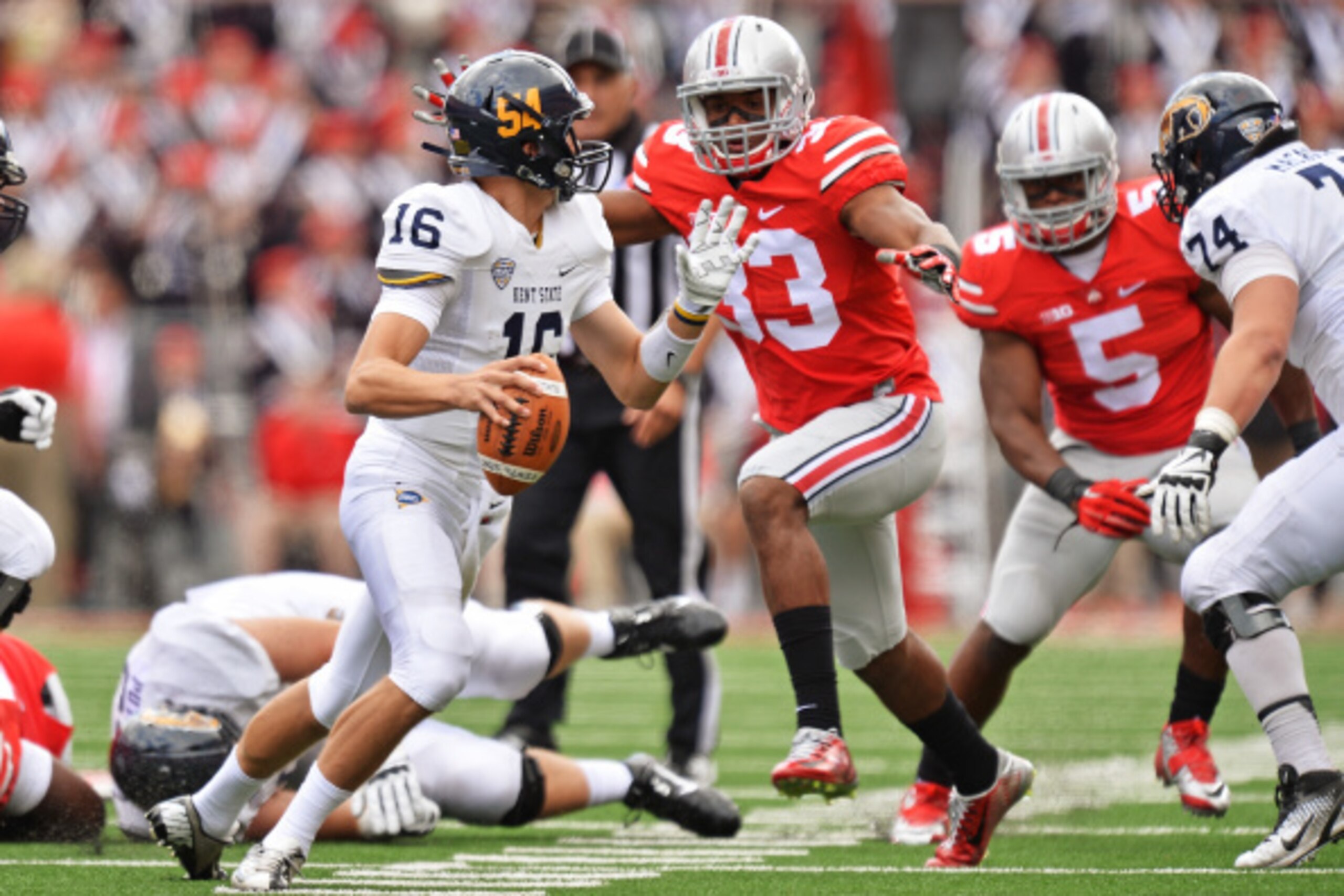 COLUMBUS, OH - SEPTEMBER 13:  Dante Booker #33 of the Ohio State Buckeyes pressures quarterback Nathan Strock #16 of the Kent State Golden Flashes in the third quarter at Ohio Stadium on September 13, 2014 in Columbus, Ohio. Ohio State defeated Kent State