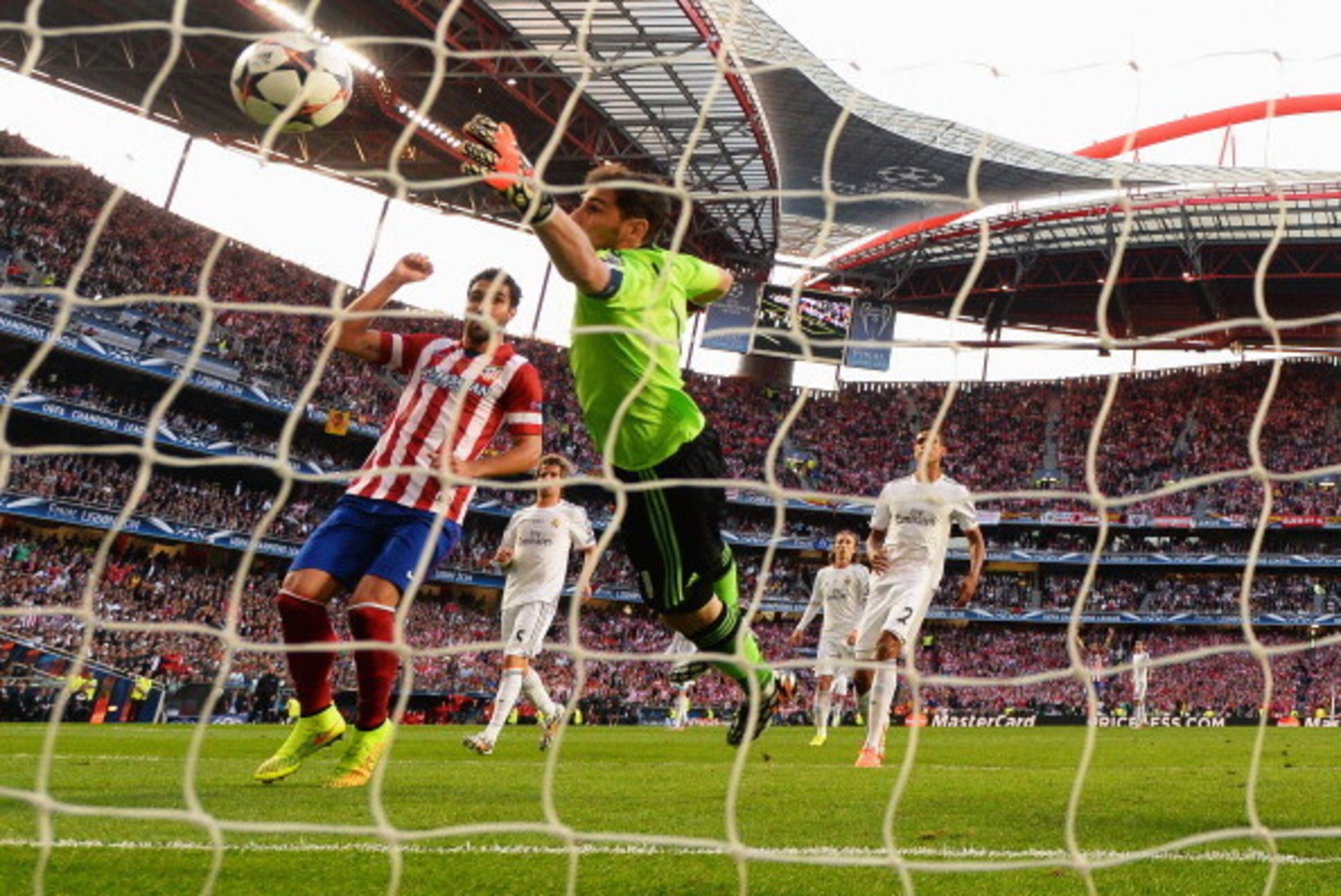 LISBON, PORTUGAL - MAY 24:  Iker Casillas of Real Madrid fails to stop the ball headed in by Diego Godin of Club Atletico de Madrid (not pictured) for the first goal during the UEFA Champions League Final between Real Madrid and Atletico de Madrid at Esta