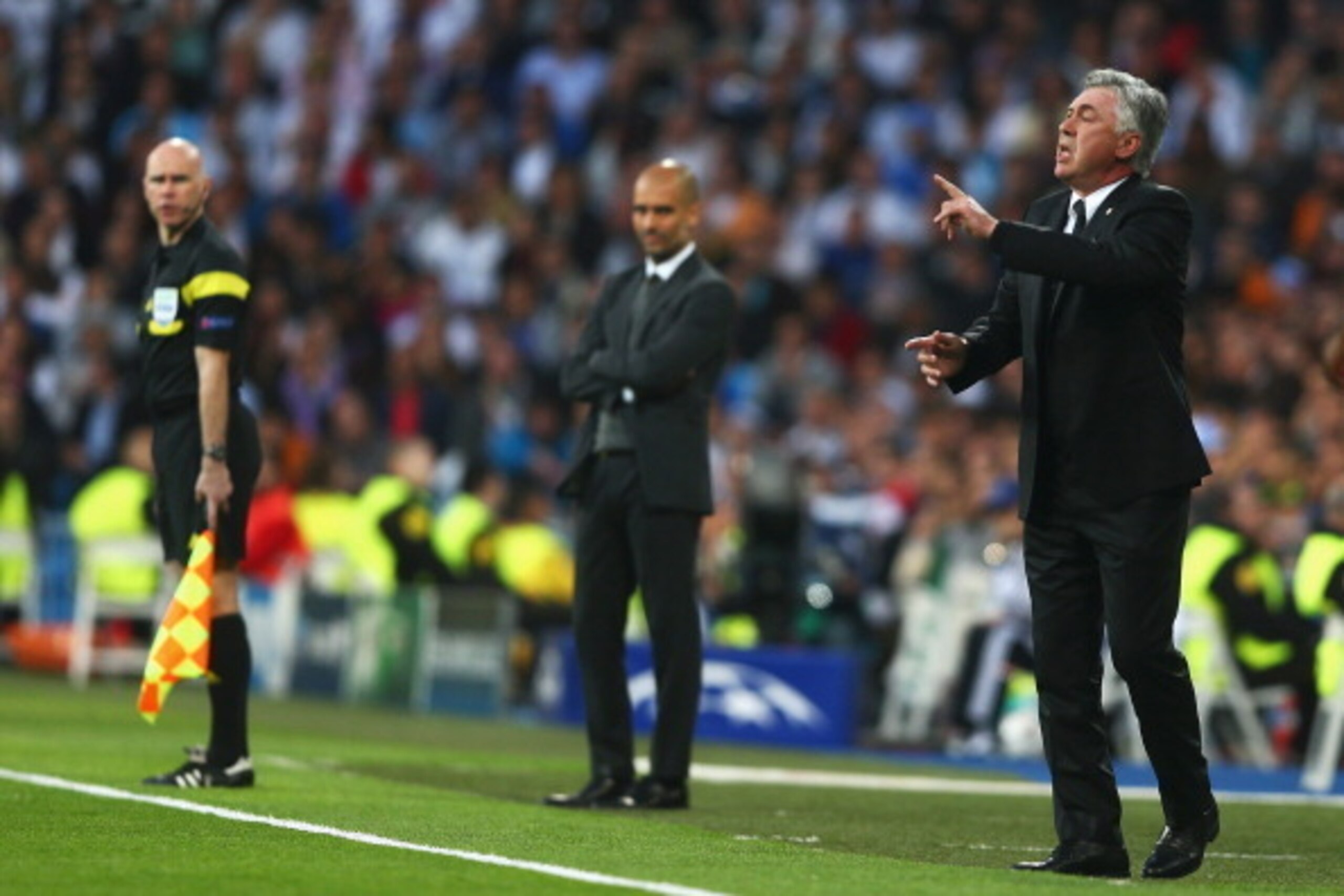 MADRID, SPAIN - APRIL 23:  Carlo Ancelotti, coach of Real Madrid gives instructions with Josep Guardiola , coach of Bayern Muenchen during the UEFA Champions League semi-final first leg match between Real Madrid and FC Bayern Muenchen at the Estadio Santi