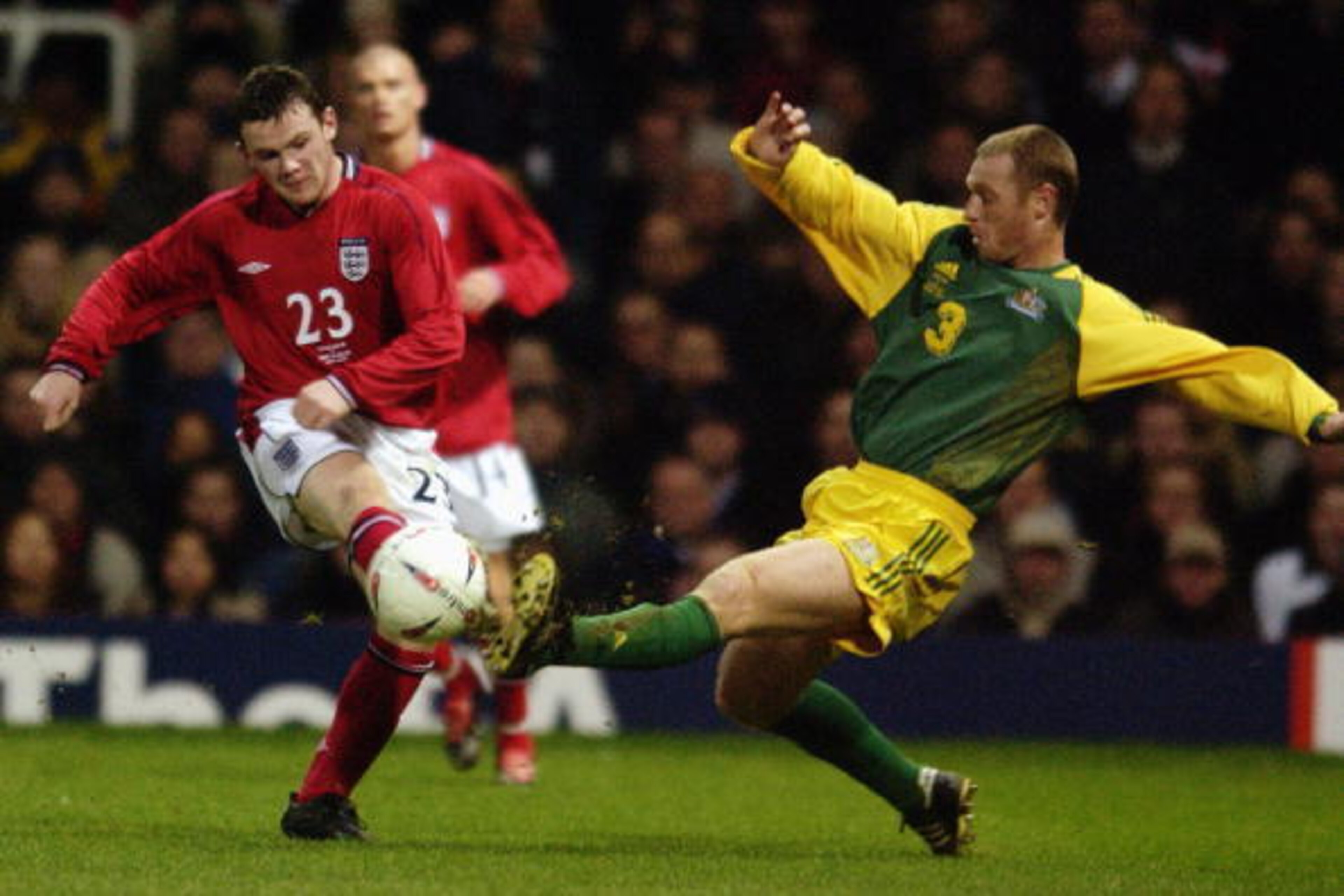 LONDON - FEBRUARY 12:  Wayne Rooney (No.23) of England shoots towards goal as Craig Moore of Australia closes him down during the International Friendly match between England and Australia held on February 12, 2003 at Upton Park in London. Australia won t