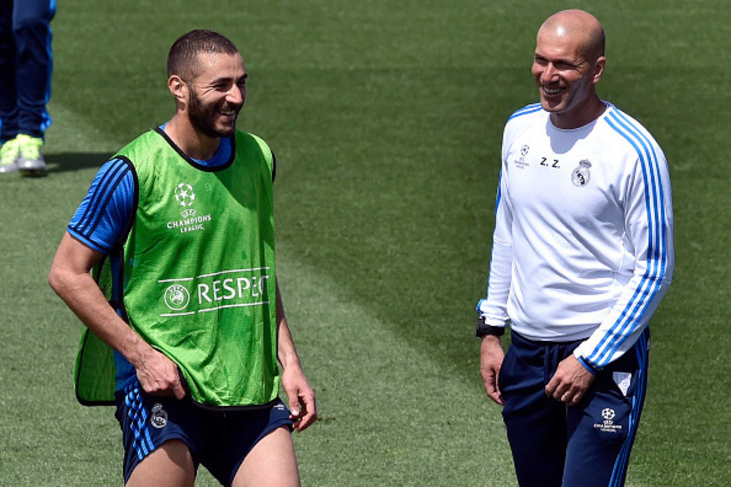 Real Madrid's French forward Karim Benzema (L) smiles with Real Madrid's French coach Zinedine Zidane as they take part in a training session on the club's Open Media Day at Real Madrid sport city in Madrid on May 24, 2016. / AFP / GERARD JULIEN        (P