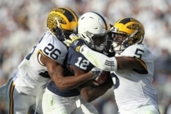 Nov 21, 2015; University Park, PA, USA; Penn State Nittany Lions wide receiver Chris Godwin (12) runs with the ball as Michigan Wolverines cornerback Jourdan Lewis (26) and safety Jabrill Peppers (5) attempt to tackle during the third quarter at Beaver St