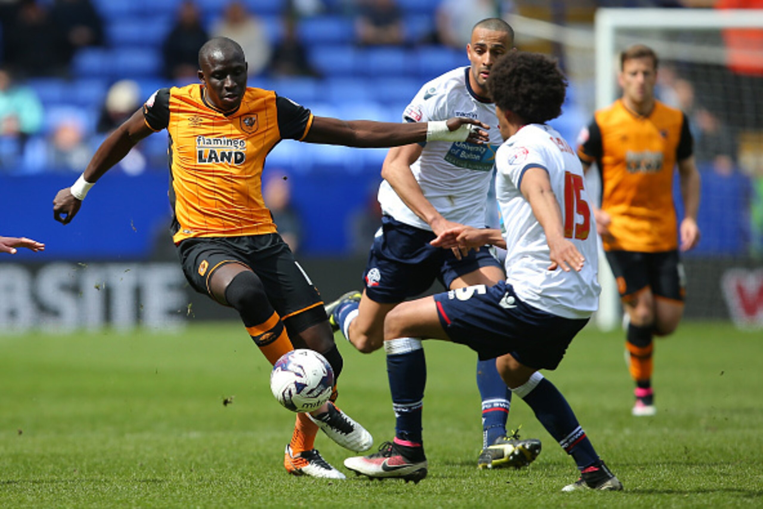 BOLTON, ENGLAND - APRIL 30: Mohamed Diame of Hull City and Derik Osede of Bolton Wanderers compete for the ball during the Sky Bet Championship match between Bolton Wanderers and Hull City at the Macron Stadium on April 30, 2016 in Bolton, United Kingdom.