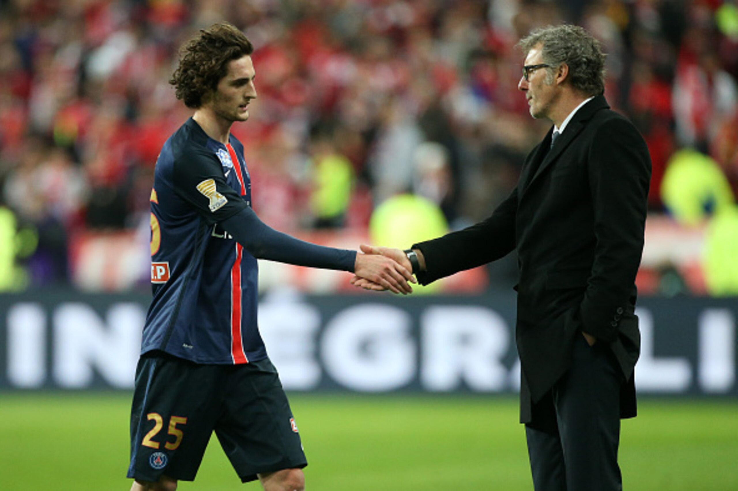PARIS, FRANCE - APRIL 23: Adrien Rabiot of PSG shakes hands with coach of PSG Laurent Blanc when he leaves the field after receiving a red card during the French League Cup final (finale de la Coupe de la Ligue) between Paris Saint-Germain (PSG) and Lille