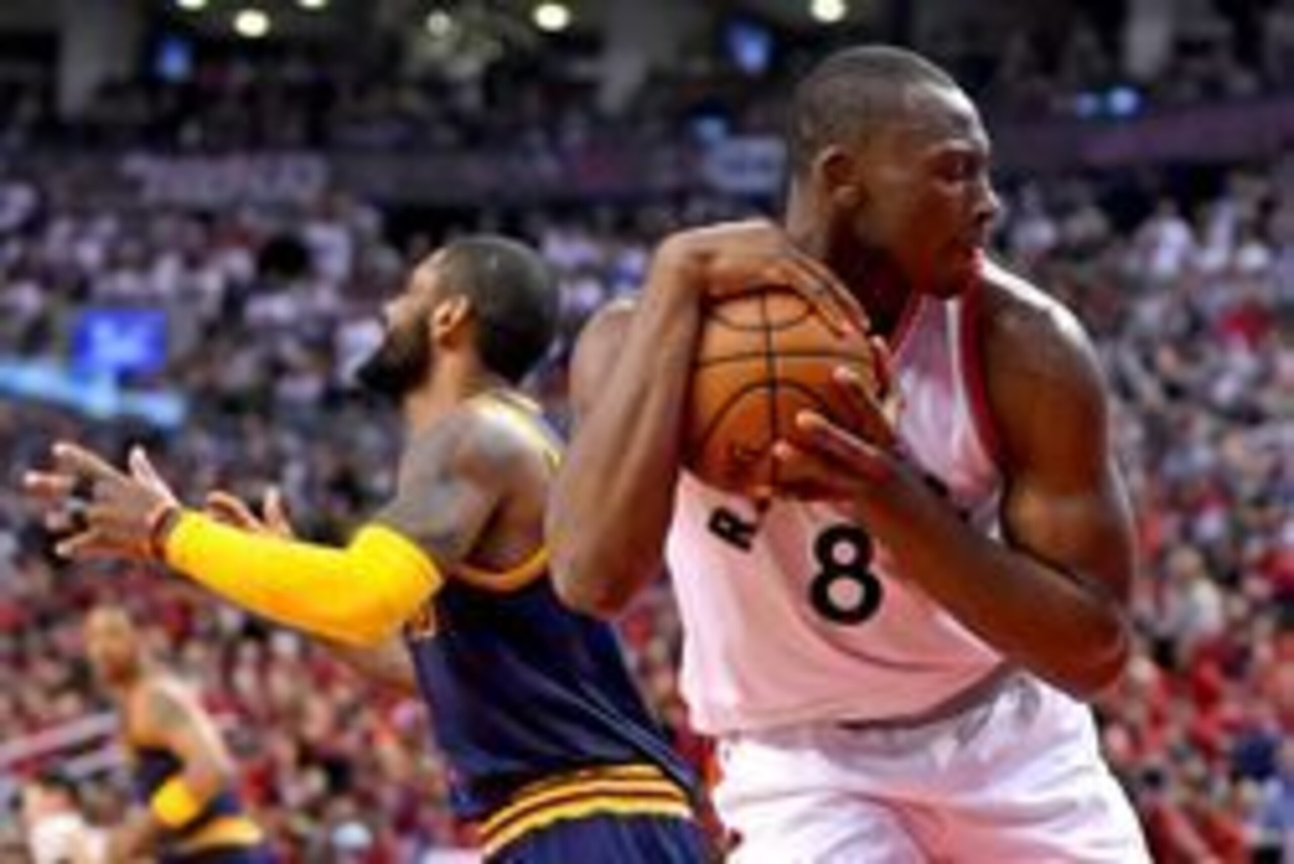 May 21, 2016; Toronto, Ontario, CAN; Toronto Raptors center Bismack Biyombo (8) clutches the ball after making a rebound in the second half of a 99-84 win over Cleveland Cavaliers in game three of the Eastern conference finals of the NBA Playoffs at Air May 21, 2016; Toronto, Ontario, CAN; Toronto Raptors center Bismack Biyombo (8) clutches the ball after making a rebound in the second half of a 99-84 win over Cleveland Cavaliers in game three of the Eastern conference finals of the NBA Playoffs at Air