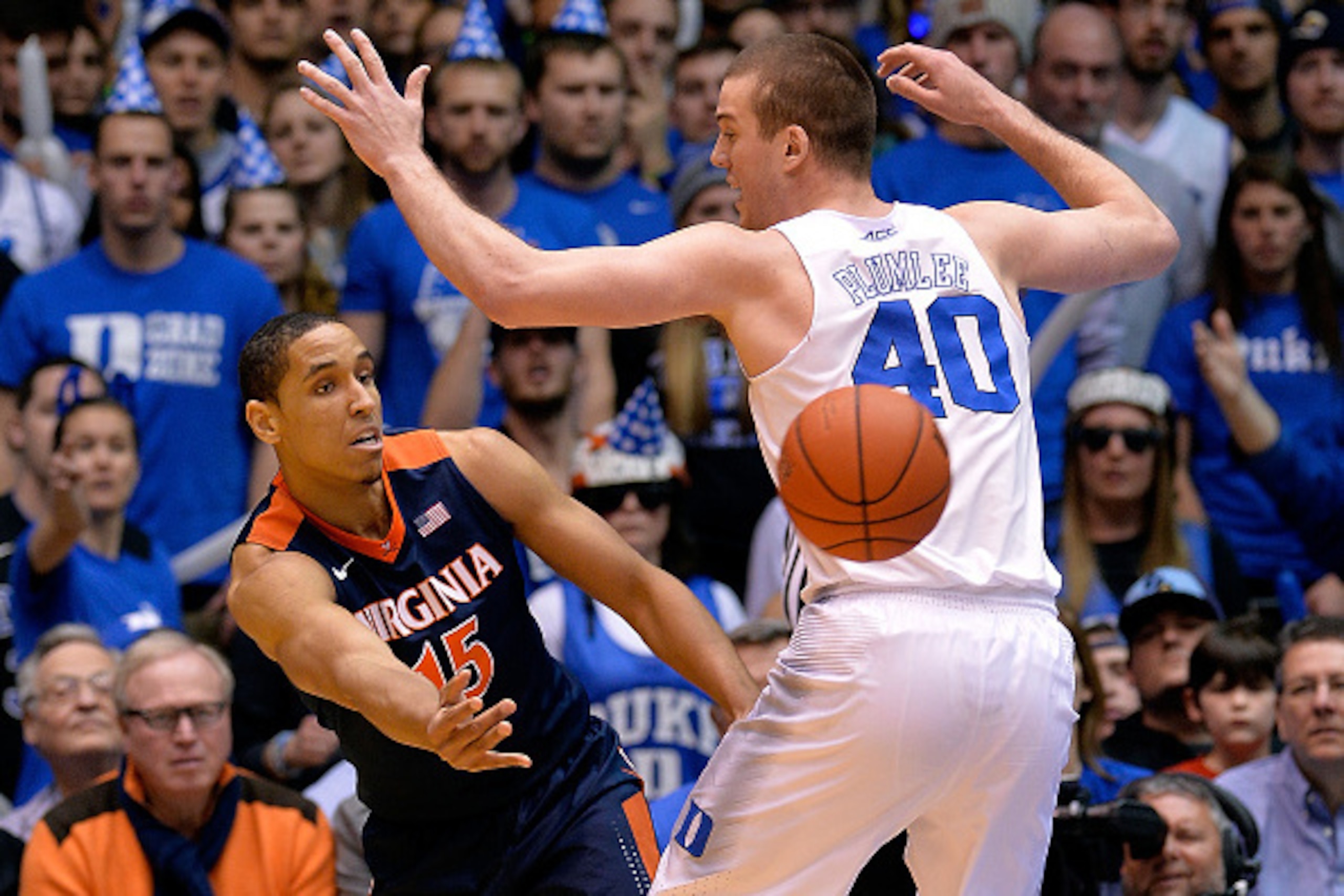 DURHAM, NC - FEBRUARY 13:  Malcolm Brogdon #15 of the Virginia Cavaliers loos to pass around Marshall Plumlee #40 of the Duke Blue Devils during their game at Cameron Indoor Stadium on February 13, 2016 in Durham, North Carolina. Duke won 63-62.  (Photo b