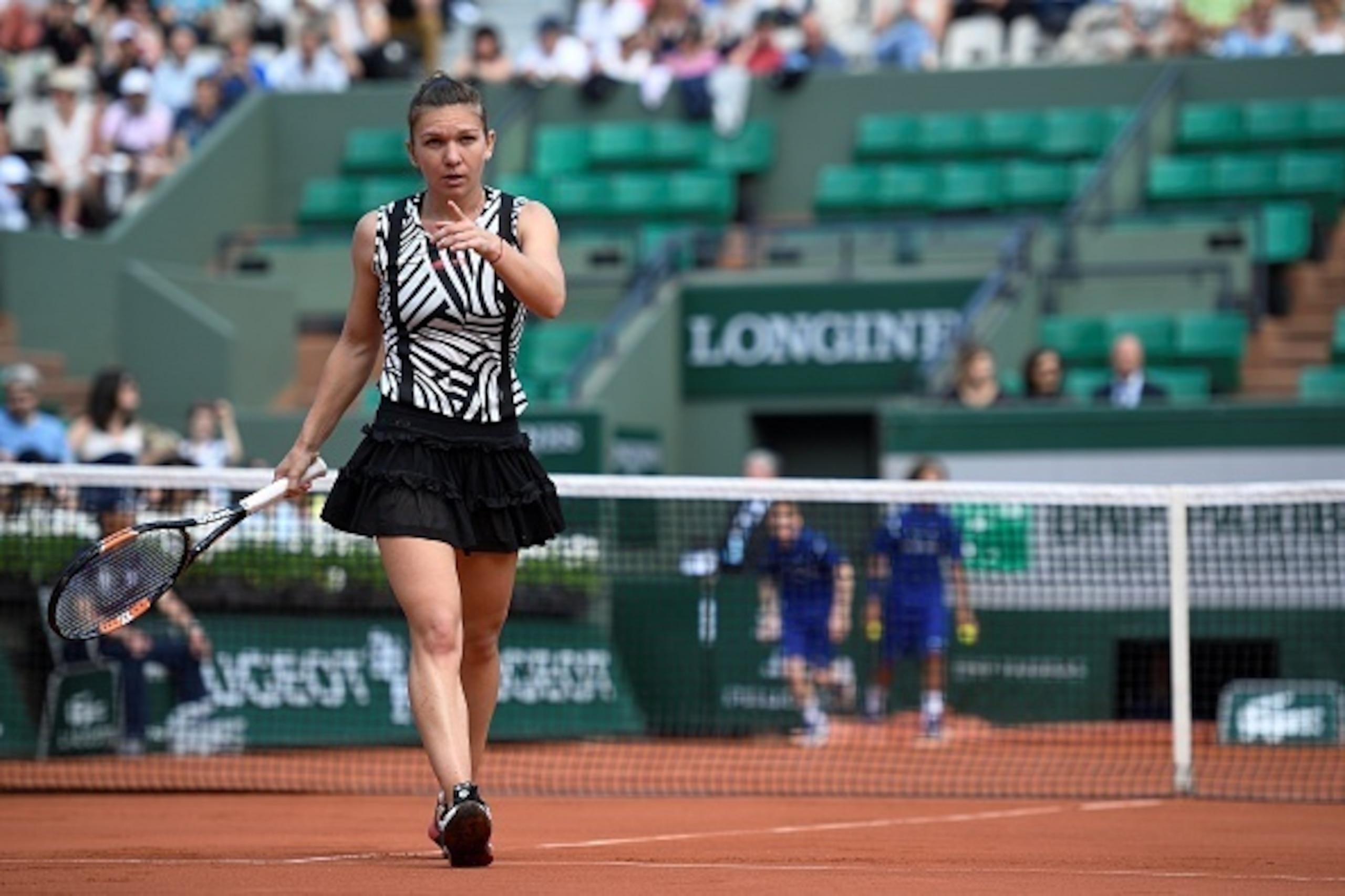 Romania's Simona Halep gestures during her women's third round match against Japan's Naomi Osaka at the Roland Garros 2016 French Tennis Open in Paris on May 27, 2016. / AFP / MARTIN BUREAU        (Photo credit should read MARTIN BUREAU/AFP/Getty Images)