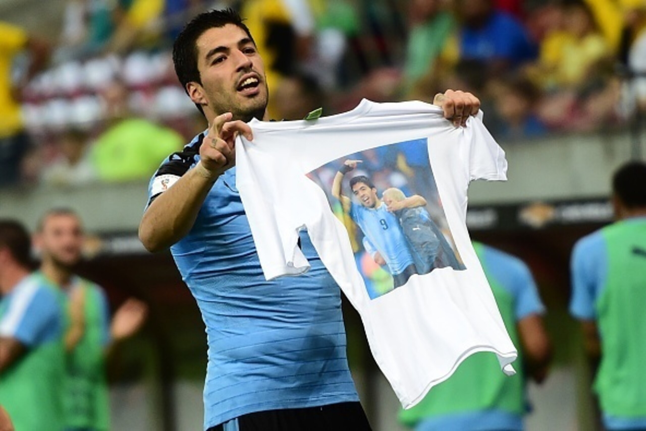Uruguay's Luis Suarez shows a t-shirt in honour of late physiotherapist Walter Ferreira, who helped him have a quick recovery of a knee injury, after scoring against Brazil during their Russia 2018 FIFA World Cup South American Qualifiers' football match,