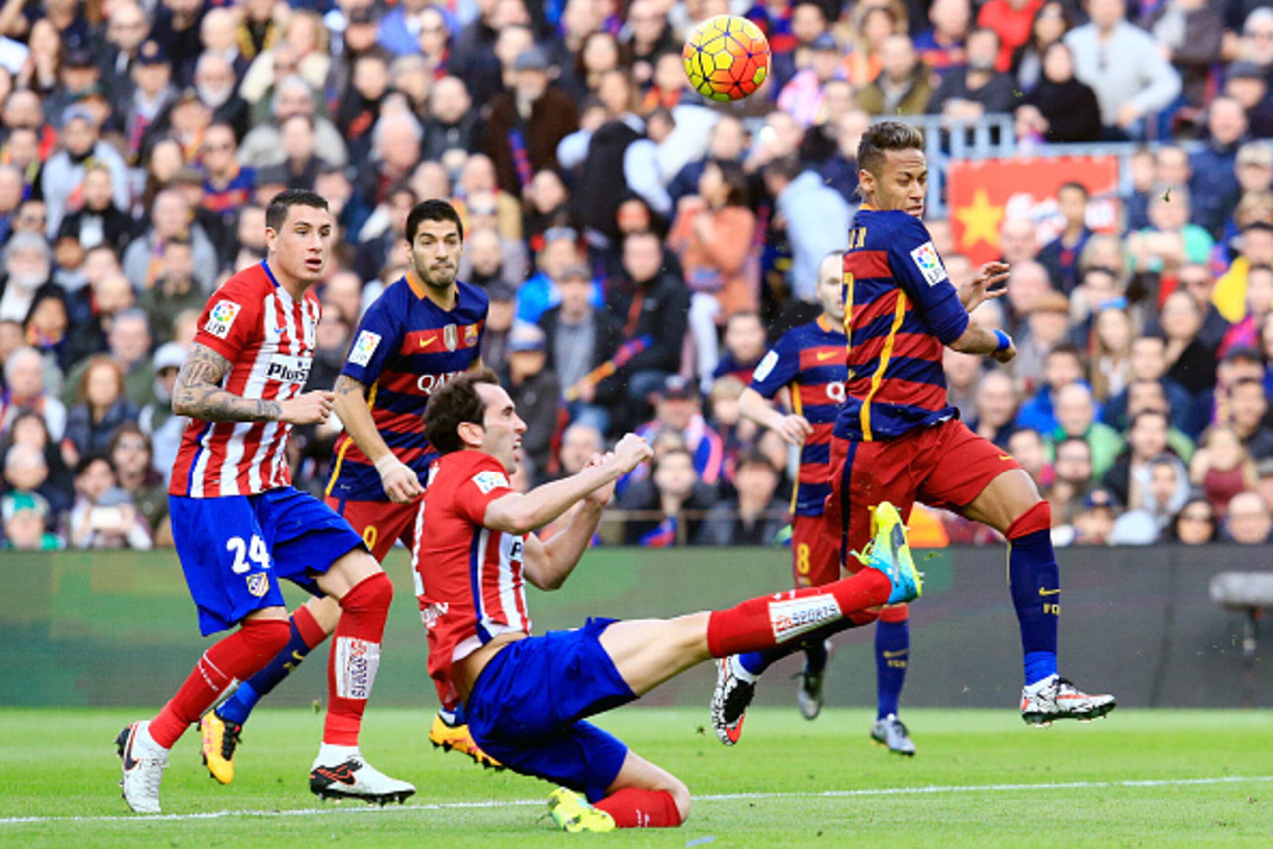 Barcelona's Brazilian forward Neymar (R) vies with Atletico Madrid's Uruguayan defender Diego Godin (C) past Atletico Madrid's Uruguayan defender Jose Maria Gimenez (L) and Barcelona's Uruguayan forward Luis Suarez during the Spanish league football match