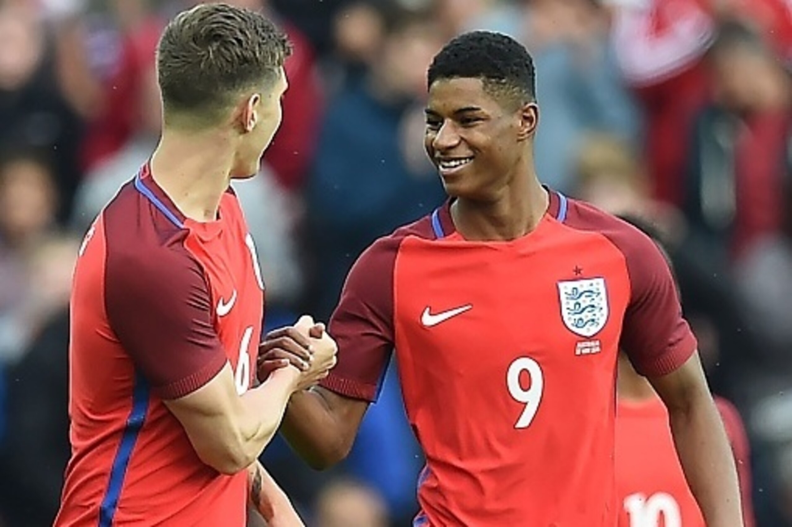 England's striker Marcus Rashford (R) celebrates after scoring his team's first goal during the International friendly football match between England and Australia at the Stadium of Light in Sunderland, north east England, on May 27, 2016. / AFP / PAUL EL