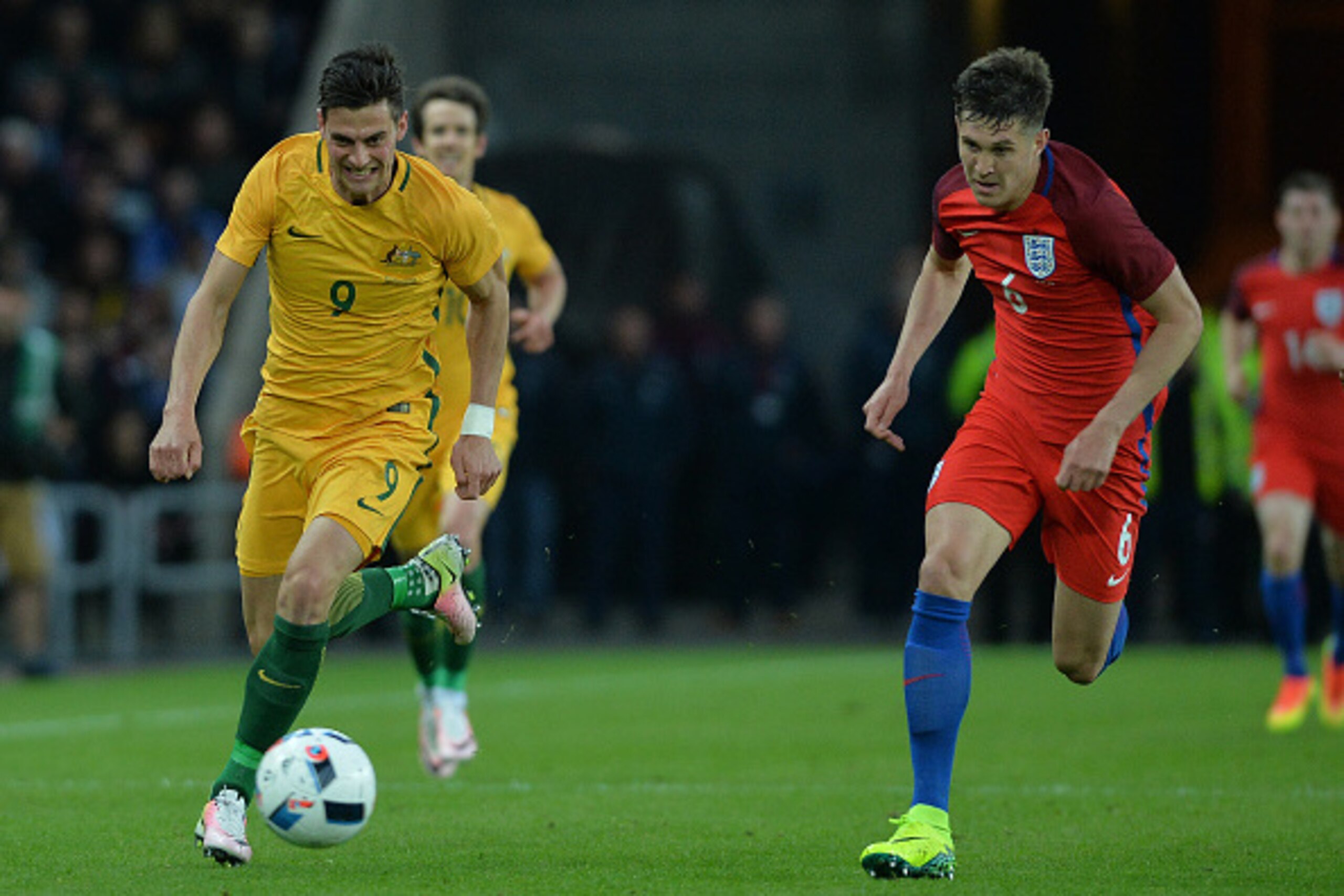 SUNDERLAND, ENGLAND - MAY 27: Tom Juric of Australia takes on John Stones of England during the International Friendly match between England and Australia at Stadium of Light on May 27, 2016 in Sunderland, England. (Photo by Mark Runnacles/Getty Images)