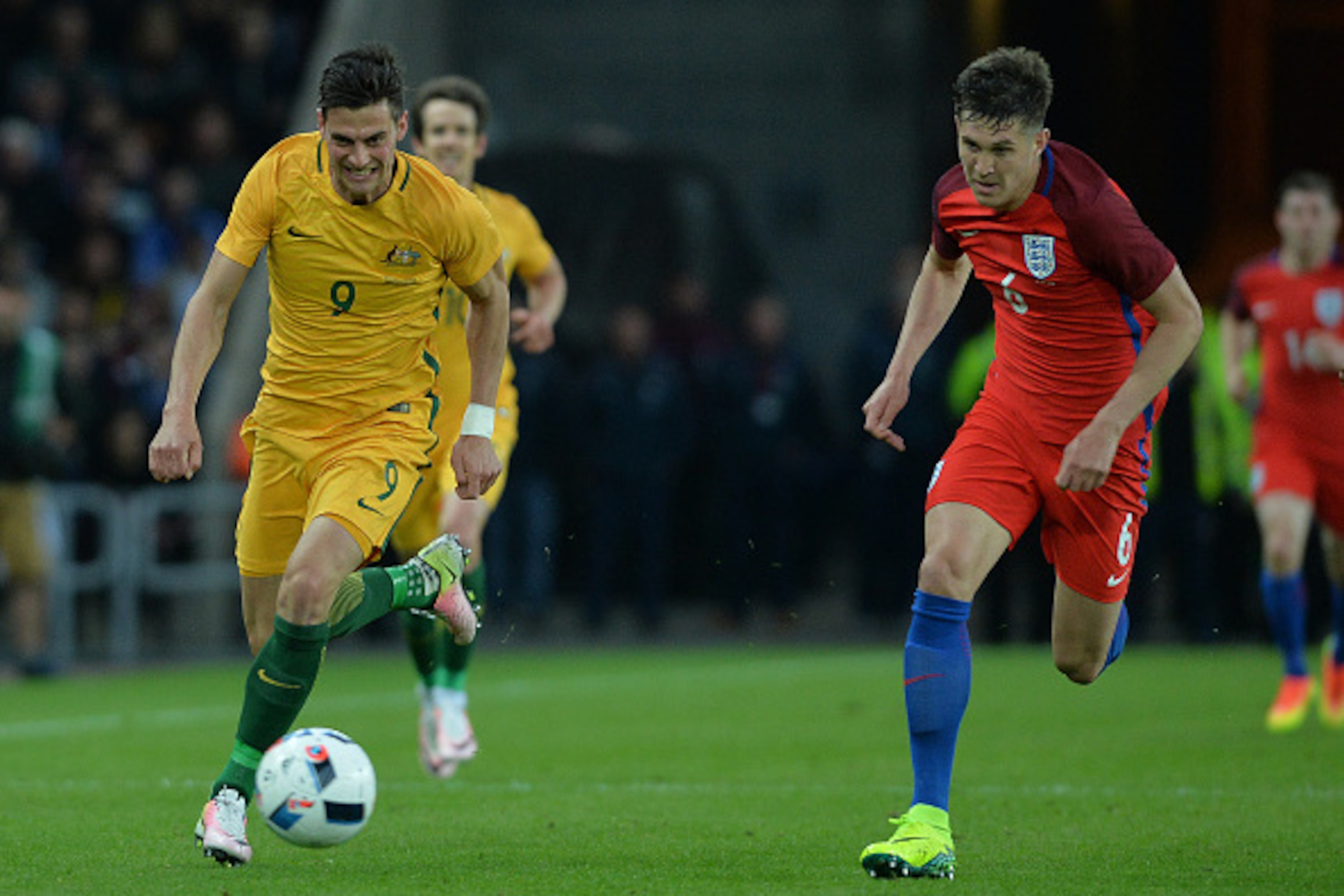 SUNDERLAND, ENGLAND - MAY 27: Tom Juric of Australia takes on John Stones of England during the International Friendly match between England and Australia at Stadium of Light on May 27, 2016 in Sunderland, England. (Photo by Mark Runnacles/Getty Images)