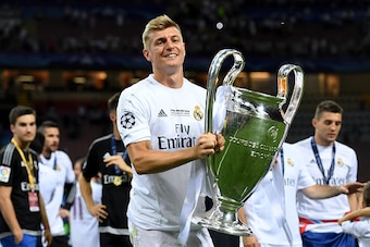 MILAN, ITALY - MAY 28:  Toni Kroos of Real Madrid  shows the trophy after winning the UEFA Champions League Final match between Real Madrid and Club Atletico de Madrid at Stadio Giuseppe Meazza on May 28, 2016 in Milan, Italy.  (Photo by Matthias Hangst/G